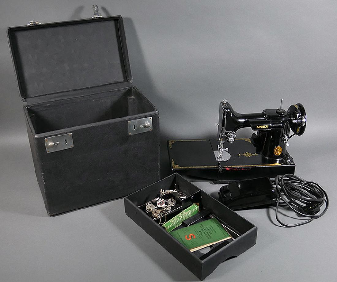 SINGER FEATHERWEIGHT 221 Sewing Machine 1948: Nice Singer 221 in case, working well, with some attachments. Excellent condition, with some red tape residue (cleanable) on front edge of deck, and some minor surface wear. Case in fine condition.