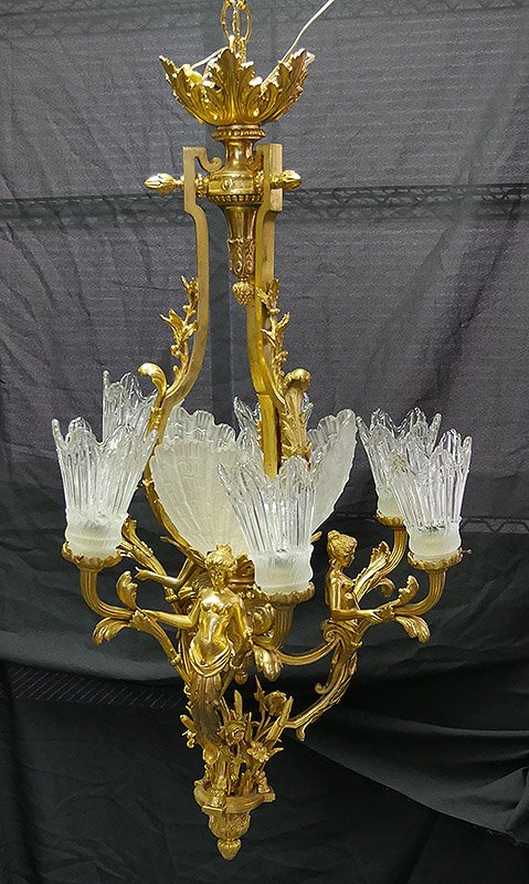Italian Gilt Bronze Nudes Acanthus Chandelier: Seven-light Italian chandelier with three nude figures holding up two lights each, with a center light framed with frosted glass shells. 41" drop from ceiling. One pair of fixtures needs minor straigh