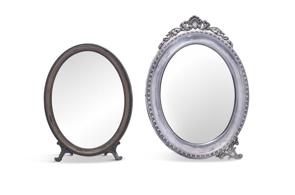 TWO CONTINENTAL SILVER DRESSING TABLE MIRRORS, .800: TWO CONTINENTAL SILVER DRESSING TABLE MIRRORS, .800 standard, with oval bevelled plates, on easel back stands and scroll supports, the largest 33cm high