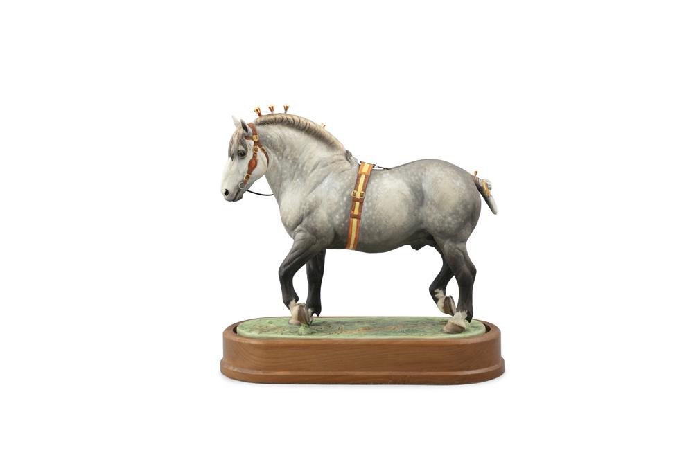 A ROYAL WORCESTER PORCELAIN MODEL OF A PERCHERON: A ROYAL WORCESTER PORCELAIN MODEL OF A PERCHERON STALLION, modelled by Doris Lindner, model no.105/500, set into an oval timber base, with certificate. 25.5 x 8.2 x 24.5cm high