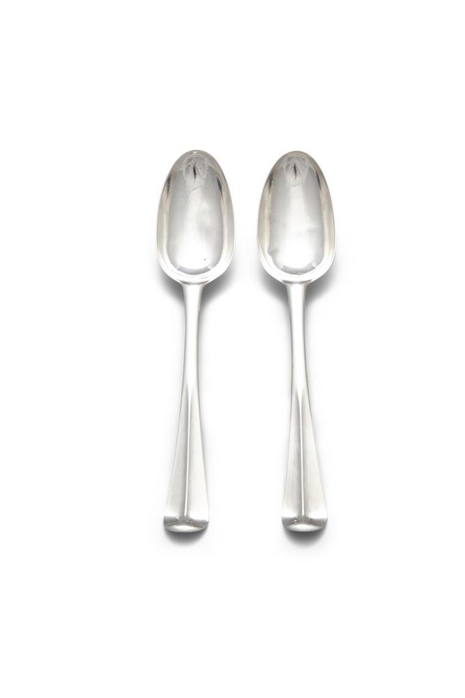 A PAIR OF IRISH SILVER GEORGIAN HANOVERIAN PATTERN: A PAIR OF IRISH SILVER GEORGIAN HANOVERIAN PATTERN TABLE SPOONS, Dublin c. 1740, maker's mark of William Ward, the back of the handle engraved with dog crest on each. (c. 4.5 troy oz. in all)