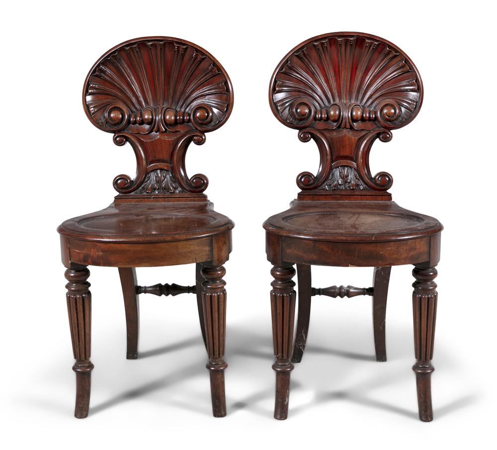 A PAIR OF REGENCY CARVED MAHOGANY HALL CHAIRS, with (1 of 2)