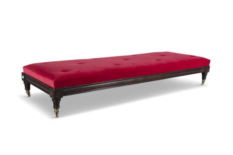 A MAHOGANY FRAMED DAY BED, 19th century, the moulded frame with blocked corners, on short tapering: A MAHOGANY FRAMED DAY BED, 19th century, the moulded frame with blocked corners, on short tapering turned feet with brass castors, the drop-in top now upholstered in crimson velveteen. 75cm deep x