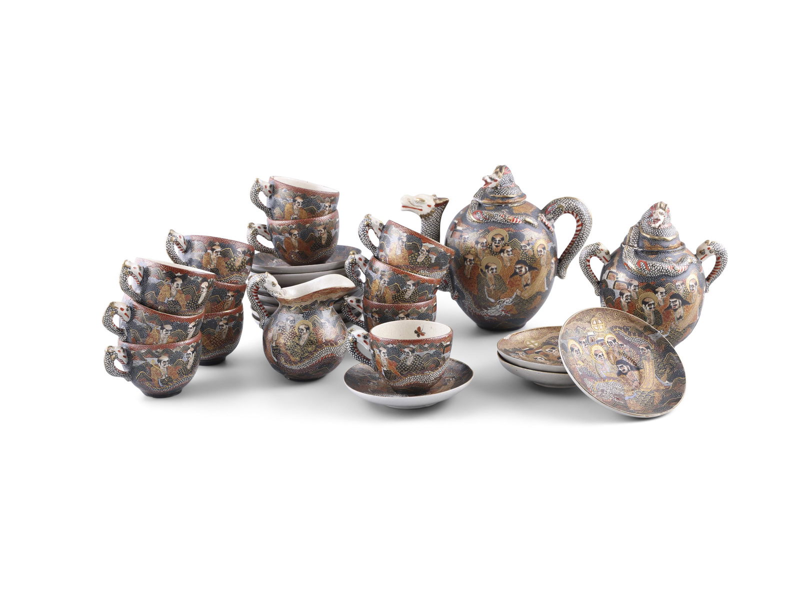 A JAPANESE SATSUMA EARTHENWARE TEASET,  decorated with figures and dragons in a mountain and river (1 of 2)