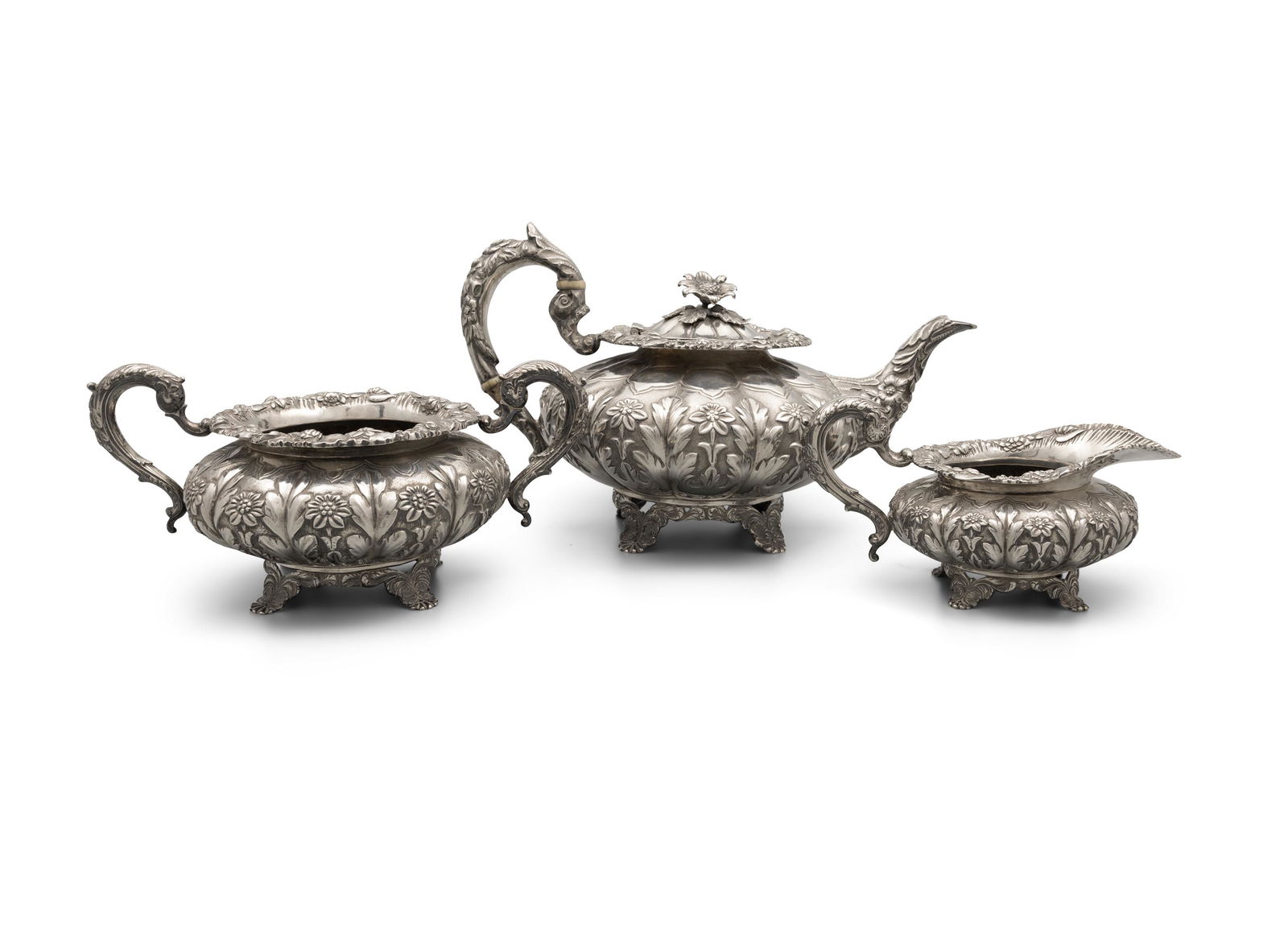 AN IRISH GEORGE III SILVER THREE PIECE TEA SERVICE Dublin c.1832, mark of Robert W. Smith,: AN IRISH GEORGE III SILVER THREE PIECE TEA SERVICE Dublin c.1832, mark of Robert W. Smith, comprising a teapot, sugar bowl and cream jug, of squashed melon shape, profusely embossed and chased with fl