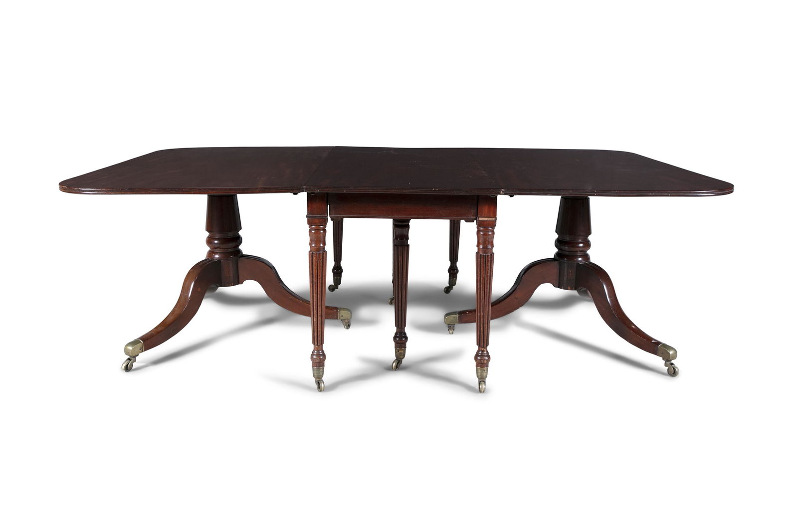 AN EARLY 19TH CENTURY MAHOGANY DINING TABLE, the ends now supported on a pair of tripod downswept: AN EARLY 19TH CENTURY MAHOGANY DINING TABLE, the ends now supported on a pair of tripod downswept pedestals with brass toe caps, with two additional leaves. 71cm high, 142cm deep, 227cm long (319cm lo