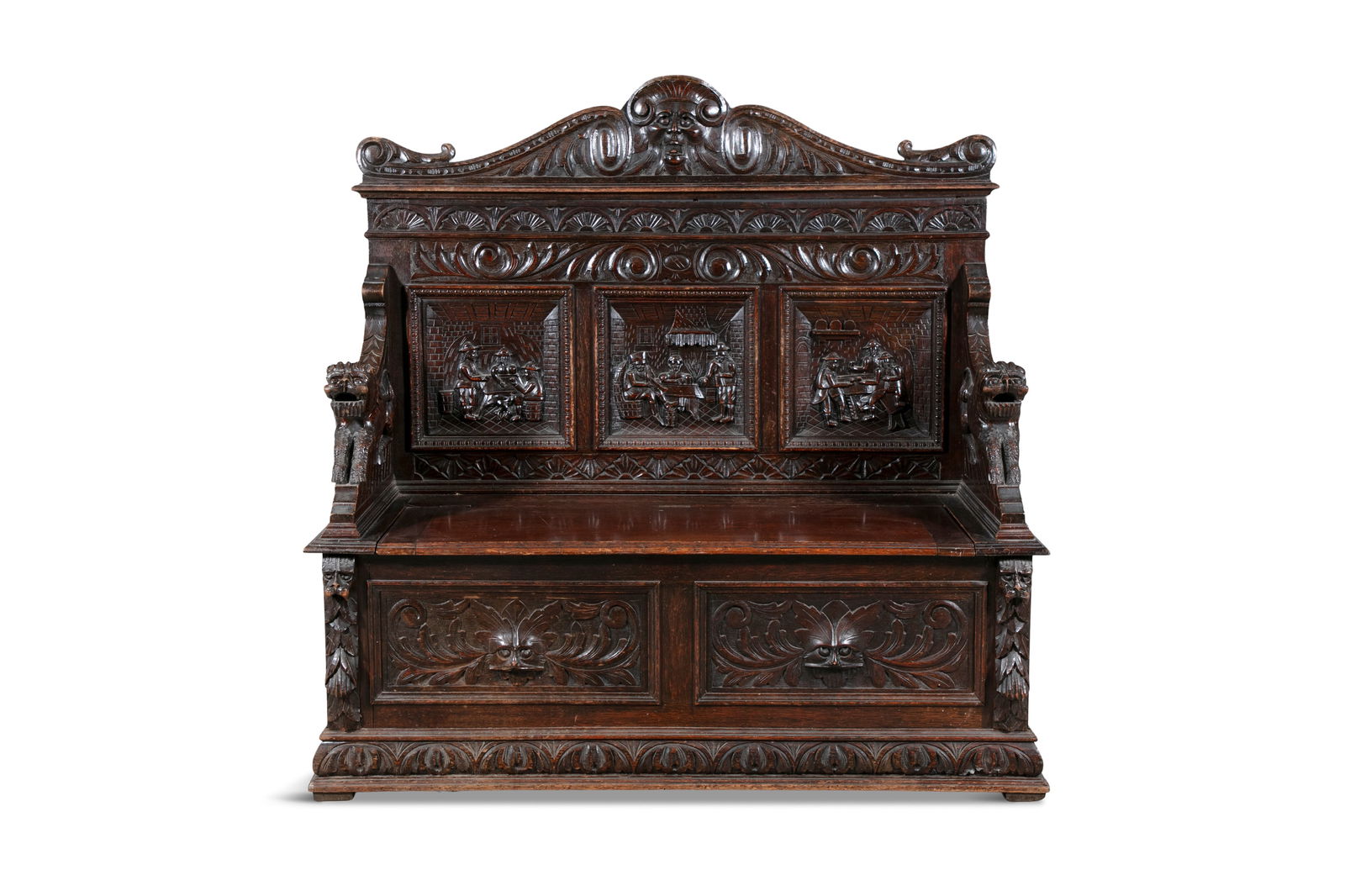 A 19TH CENTURY CARVED OAK MONKS BENCH the rectangular back with three figural panels above a: A 19TH CENTURY CARVED OAK MONKS BENCH the rectangular back with three figural panels above a hinged seat enclosing storage compartments with lion head handles and plinth base. 130cm wide