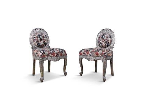 A PAIR OF ANGLO-INDIAN SILVER-WOOD UPHOLSTERED SIDE CHAIRS, C.1900 each rounded back with pierced: A PAIR OF ANGLO-INDIAN SILVER-WOOD UPHOLSTERED SIDE CHAIRS, C.1900 each rounded back with pierced foliate cresting and button upholstered roundel and seat, on serpentine seat rail and cabriole legs.