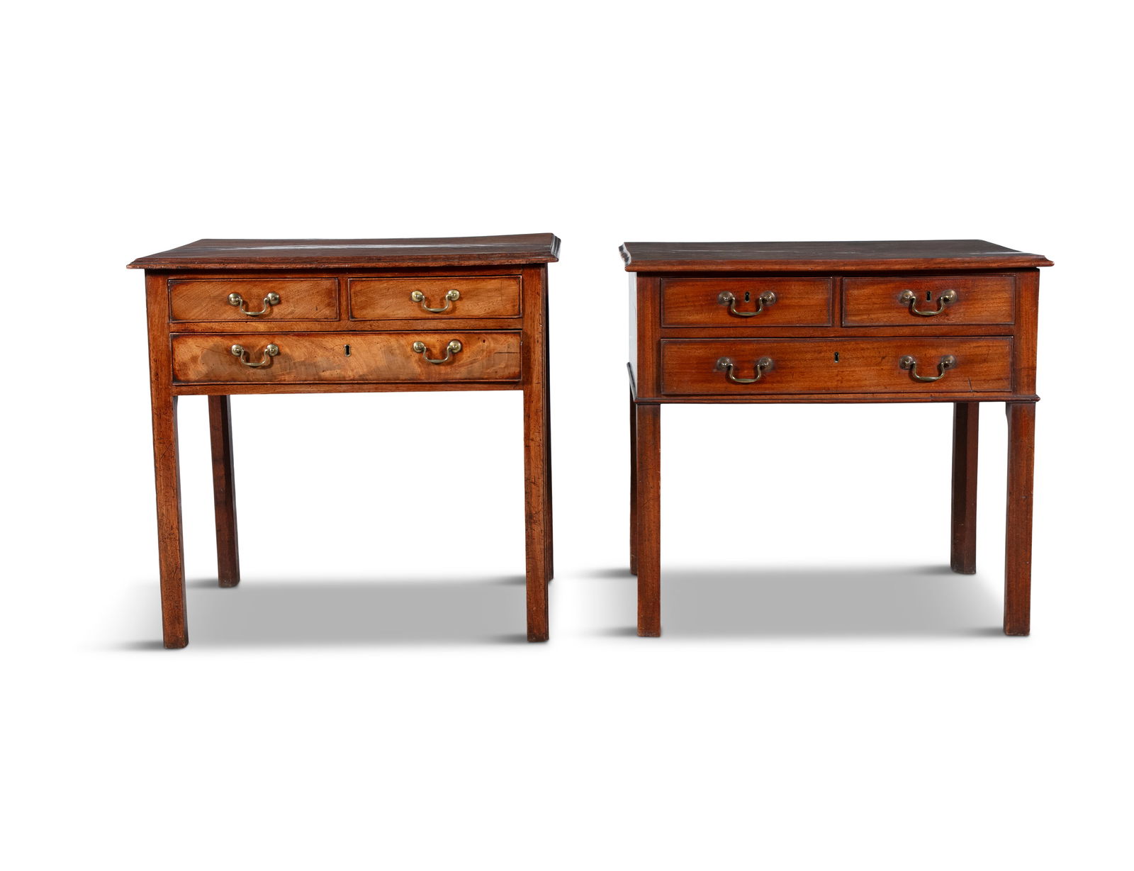 A PAIR OF GEORGE III MAHOGANY RECTANGULAR LOWBOYS, the overhanging tops with moulded rim, above two: A PAIR OF GEORGE III MAHOGANY RECTANGULAR LOWBOYS, the overhanging tops with moulded rim, above two short and one long drawer, with brass handles, raised on square chamfered legs. 76 x 46.5 x 72cm hig