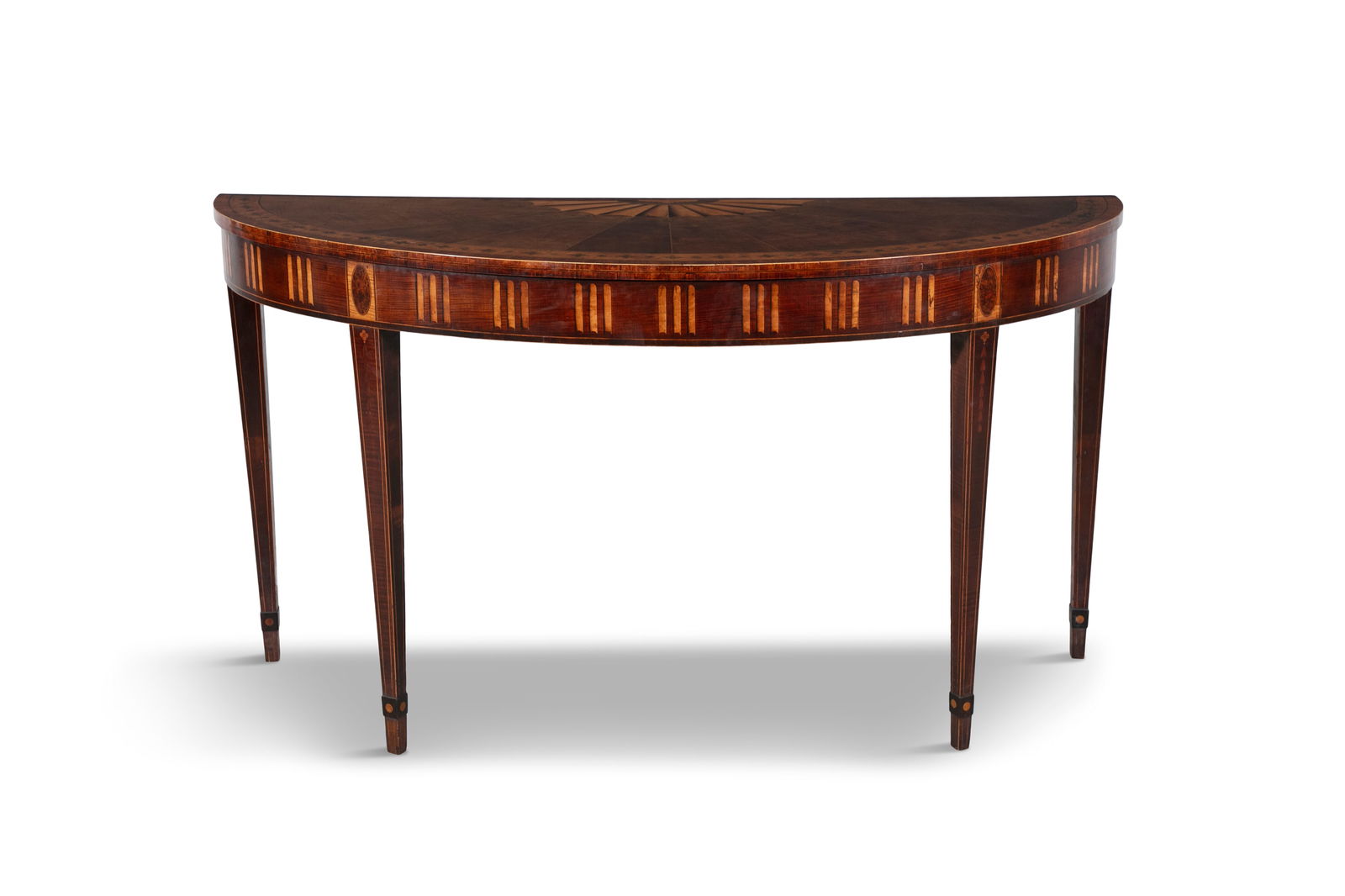 A LARGE IRISH GEORGE III SEMI ELIPTICAL CONSOLE TABLE ATTRIBUTED TO WILLIAM MOORE, C.1780 the top w: A LARGE IRISH GEORGE III SEMI ELIPTICAL CONSOLE TABLE ATTRIBUTED TO WILLIAM MOORE, C.1780 the top with radial veneers and half-patera enclosed by a crossbanded border and bands of alternating quatrefo
