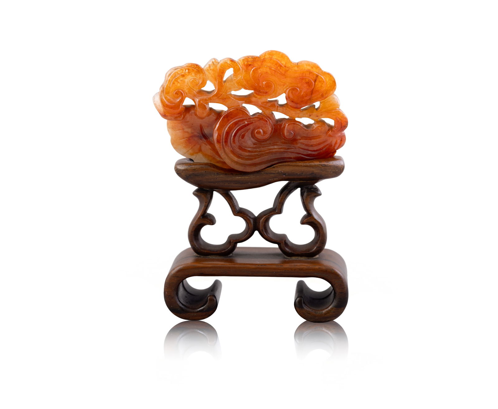 AN AGATE PENDANT  China, 19th century.  the carnelian pendant carved with a lingzhi fungas with wood (1 of 4)