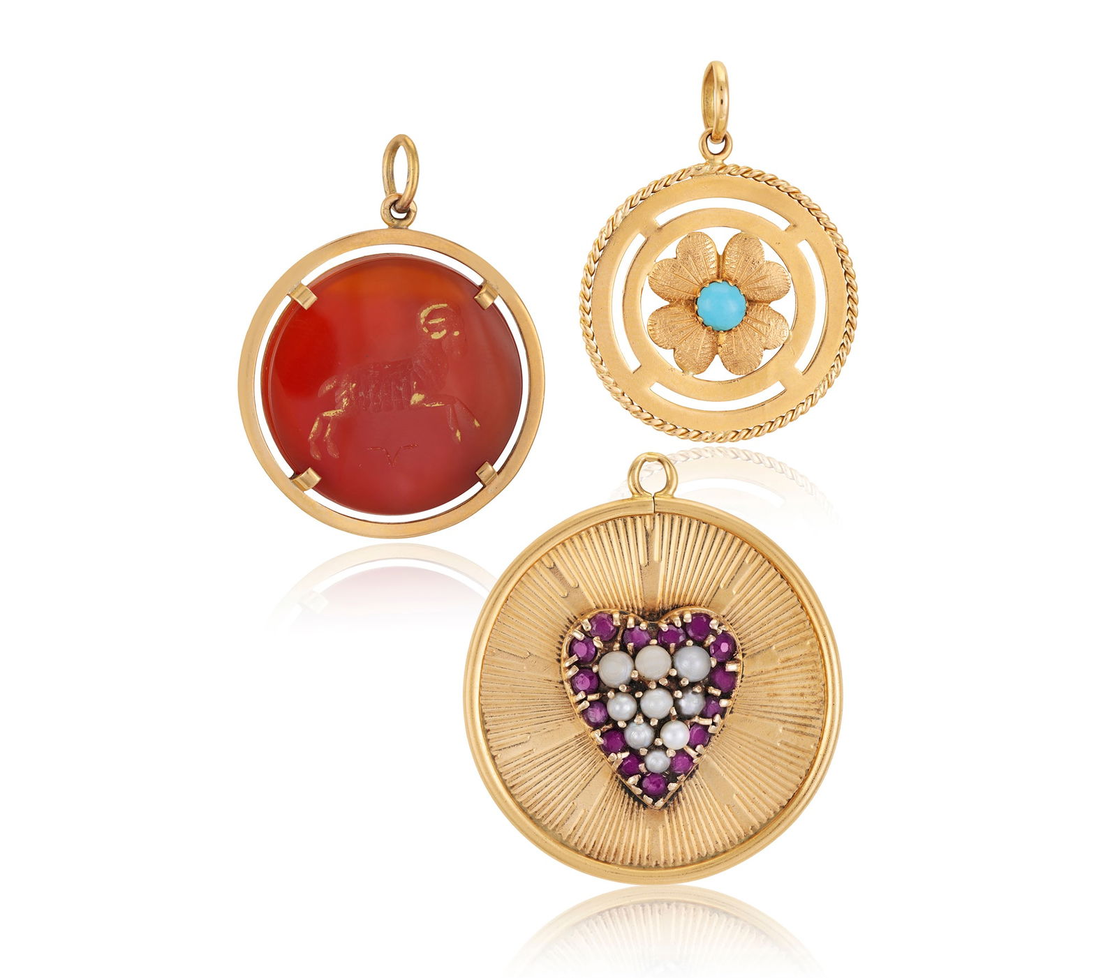 THREE GEM-SET CIRCULAR PENDANTS, including a pendant with a central pavé-set seed-pearl and ruby (1 of 4)