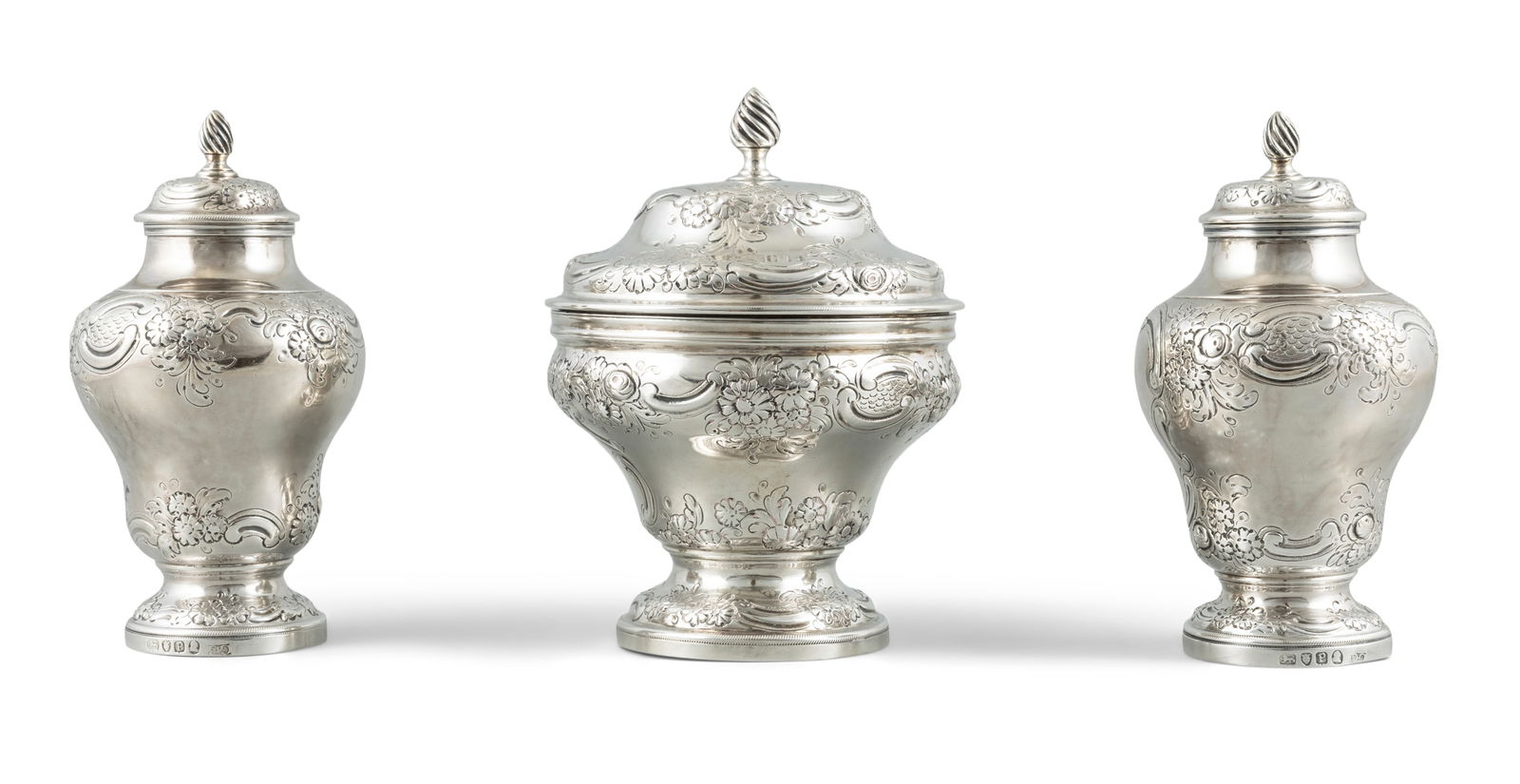 A SUITE OF GEORGE III SILVER TEA CADDIES AND MATCHING MIXING BOWL AND LID, London 1790, mark of: A SUITE OF GEORGE III SILVER TEA CADDIES AND MATCHING MIXING BOWL AND LID, London 1790, mark of George Gray, each of circular baluster form with chased and engraved foliate decoration and raised on pe