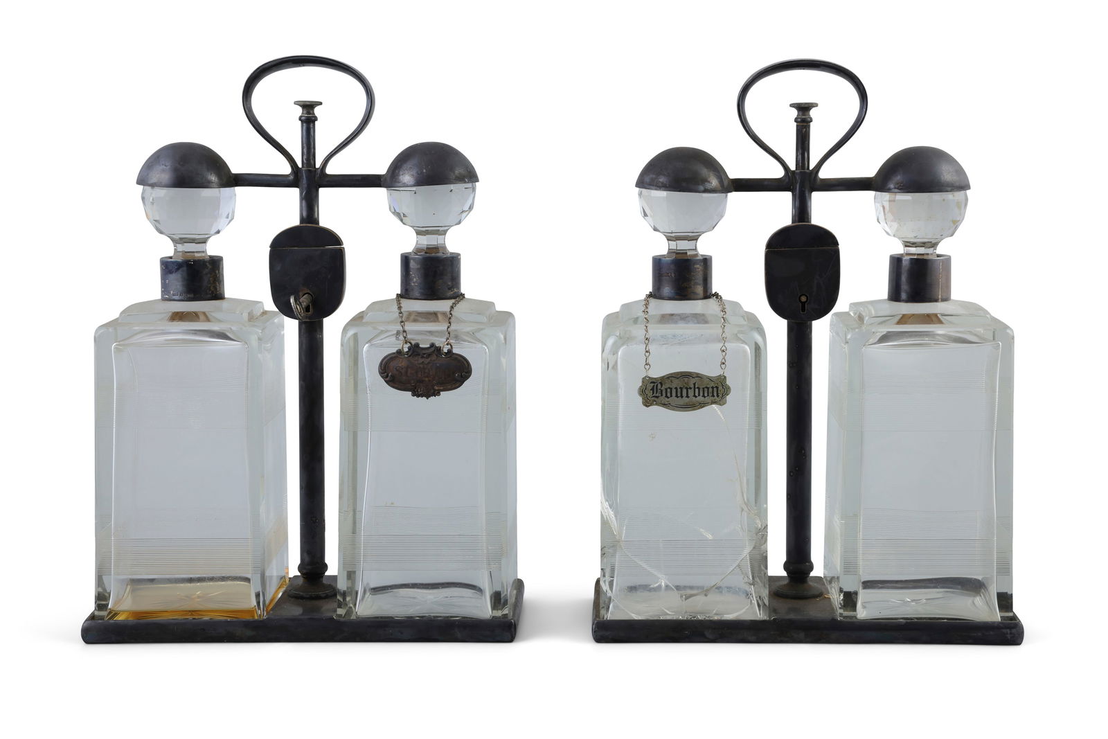 A PAIR OF SPIN TOP DOUBLE DECANTER TANTALUS BY HUKIN & HEATH   each carrying frame with locking (1 of 2)