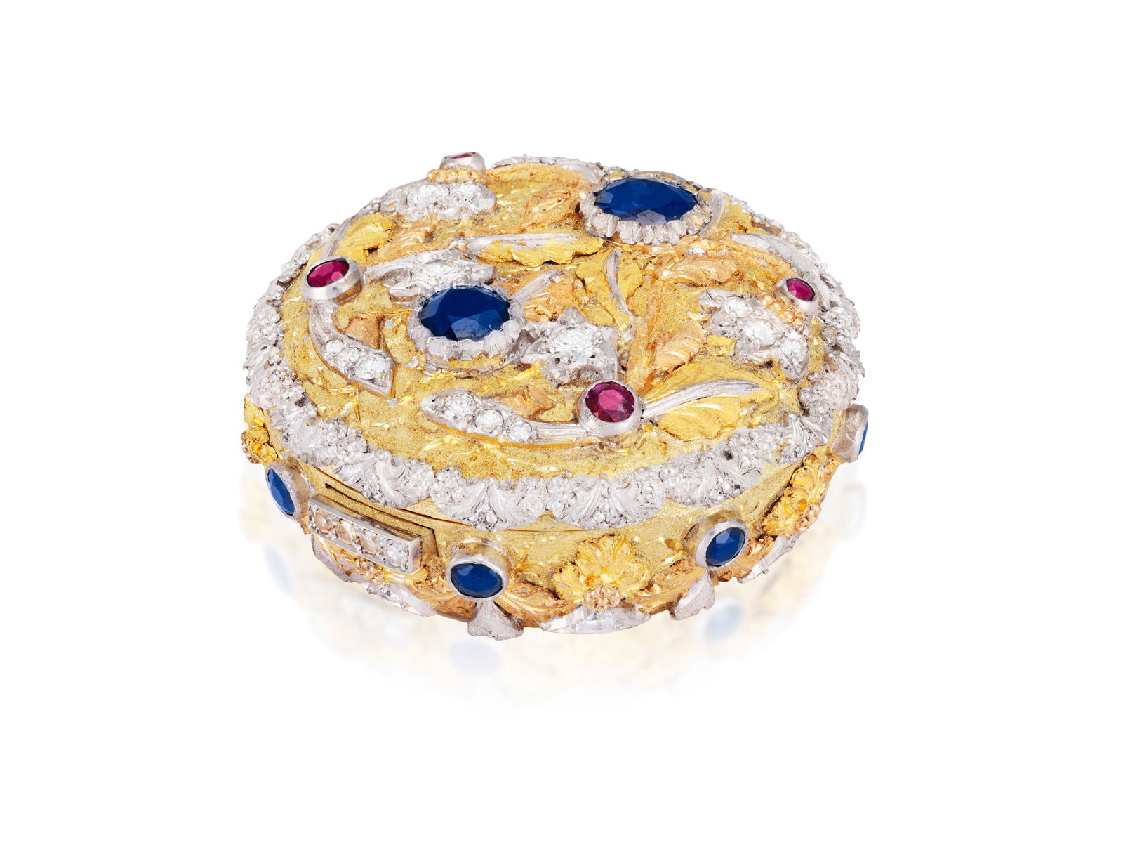 A GEM-SET AND DIAMOND PILL BOX, BY CAZZANIGA: A GEM-SET AND DIAMOND PILL BOX, BY CAZZANIGAThe bi-coloured circular box decorated with floral and scrolled motifs, set throughout with circular-cut sapphire and rubies and brilliant-cut diamonds, pus