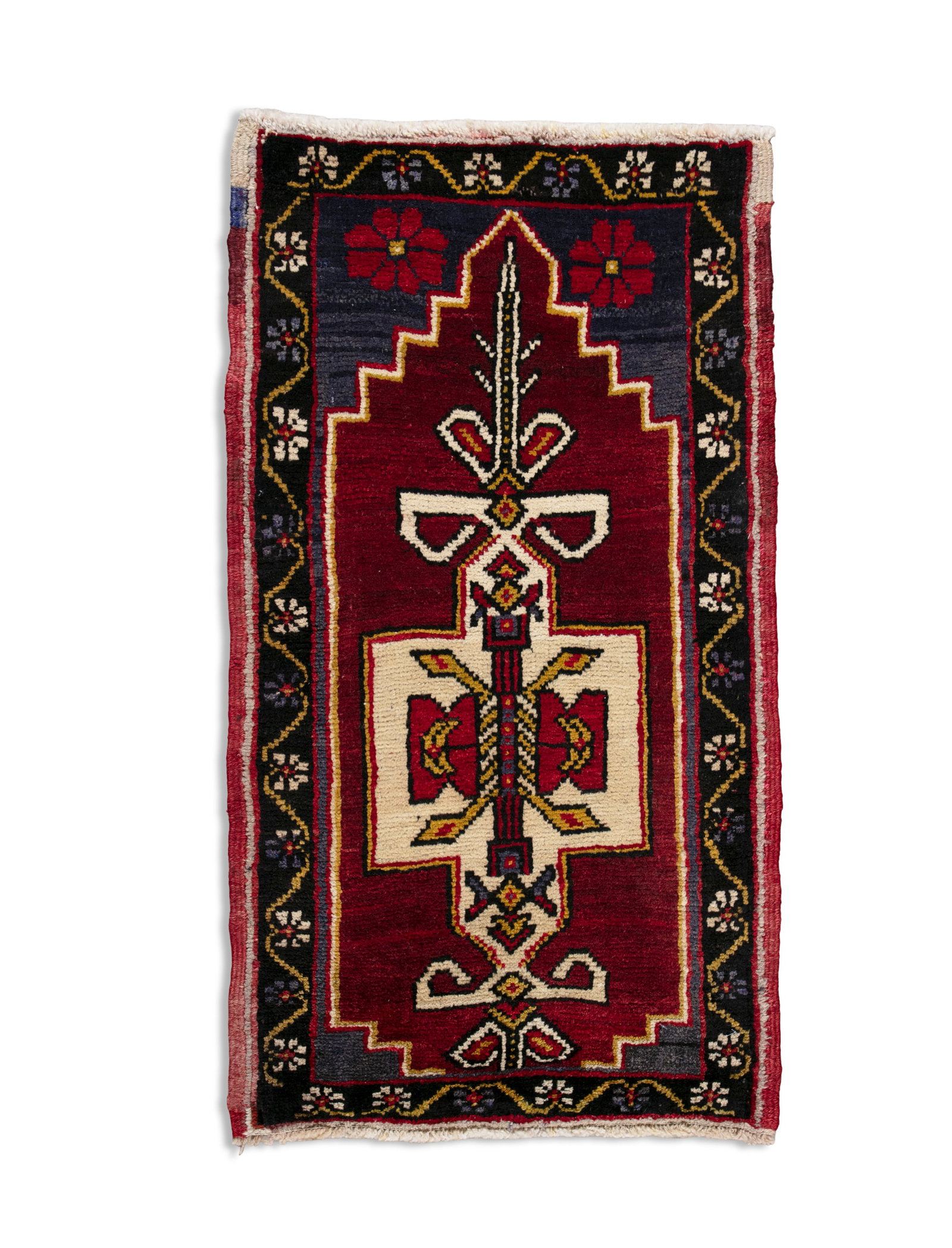 A TASPINAR WOOL PRAYER RUG, TURKEY, C.1960. 105 x 57CM the central field woven with a pointed mihr: A TASPINAR WOOL PRAYER RUG, TURKEY, C.1960. 105 x 57CM the central field woven with a pointed mihrab, with twin red flowers against a blue ground, surrounded by a scrolling floral border