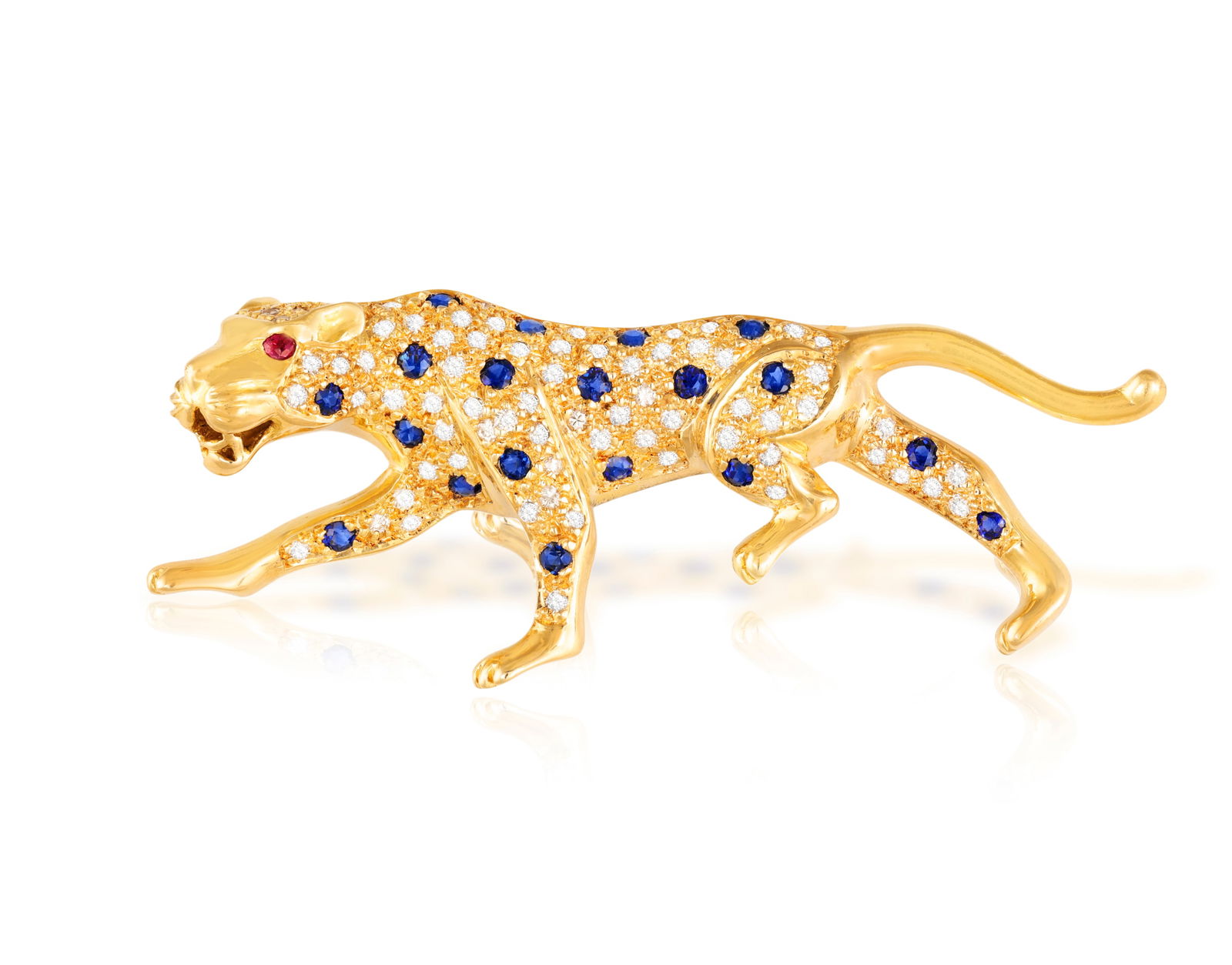 BUCHERER: A GEM-SET AND DIAMOND-SET LEOPOARD BROOCH Designed as a hunting leopard, the body pav: BUCHERER: A GEM-SET AND DIAMOND-SET LEOPOARD BROOCH Designed as a hunting leopard, the body pavé-set with brilliant-cut diamonds highlighted with circular-cut sapphire spots, circular-cut rubies