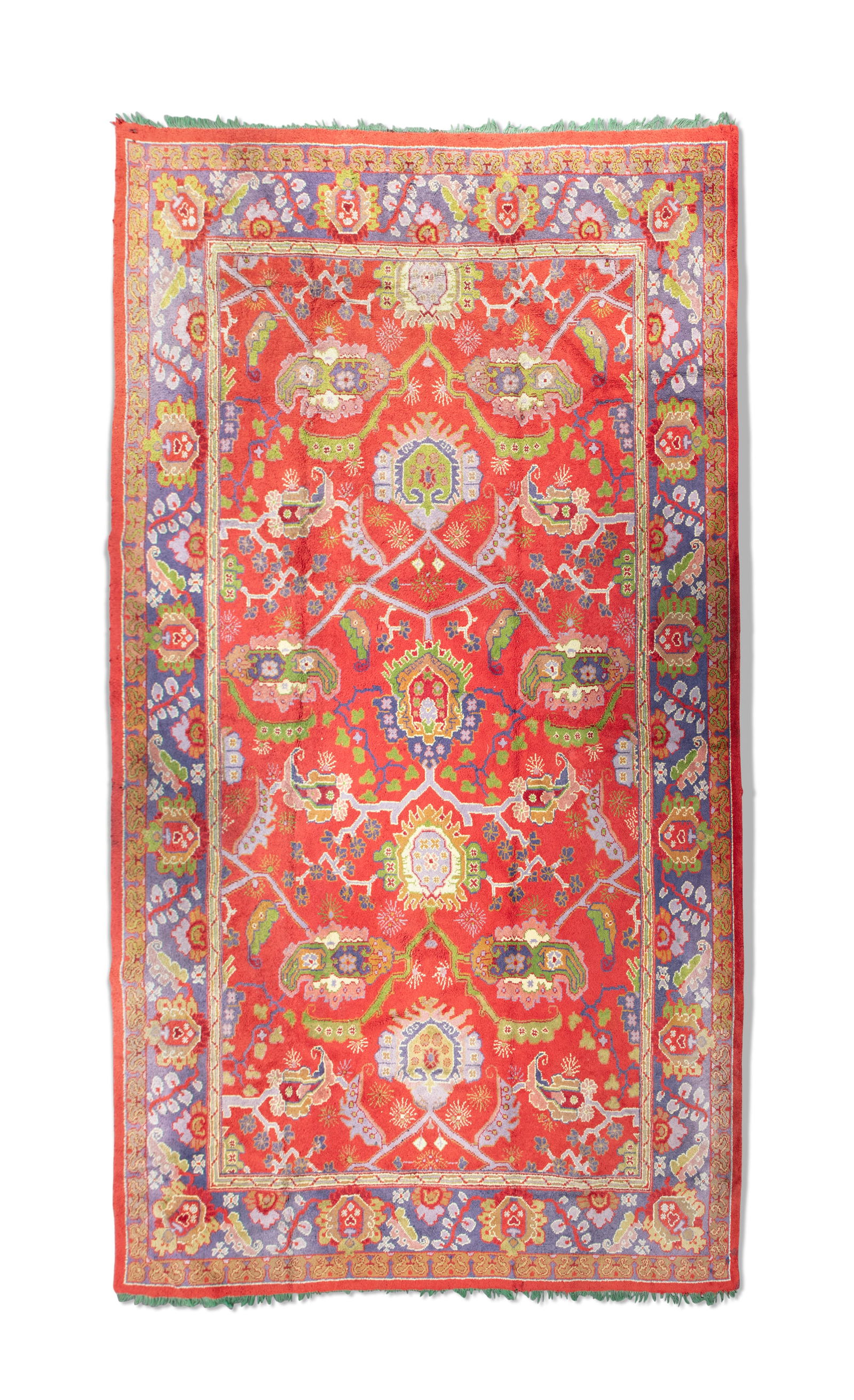 A LARGE DONEGAL CARPET ATTRIBUTED TO GAVIN MORTON & G.K. ROBERTSON, 600 x 417CM the central reserve: A LARGE DONEGAL CARPET ATTRIBUTED TO GAVIN MORTON & G.K. ROBERTSON, 600 x 417CM the central reserve woven with stylised polychrome flower heads against a red ground, contained within a broad blue grou