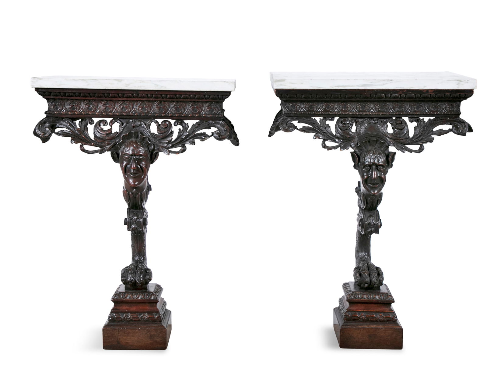 A PAIR OF IRISH GEORGE II STYLE CARVED MAHOGANY VEINED WHITE MARBLE TOP CONSOLE TABLES, each fitted: A PAIR OF IRISH GEORGE II STYLE CARVED MAHOGANY VEINED WHITE MARBLE TOP CONSOLE TABLES, each fitted with rectangular mottled tops above a leaf carved frieze and pierced apron, on masked scroll support