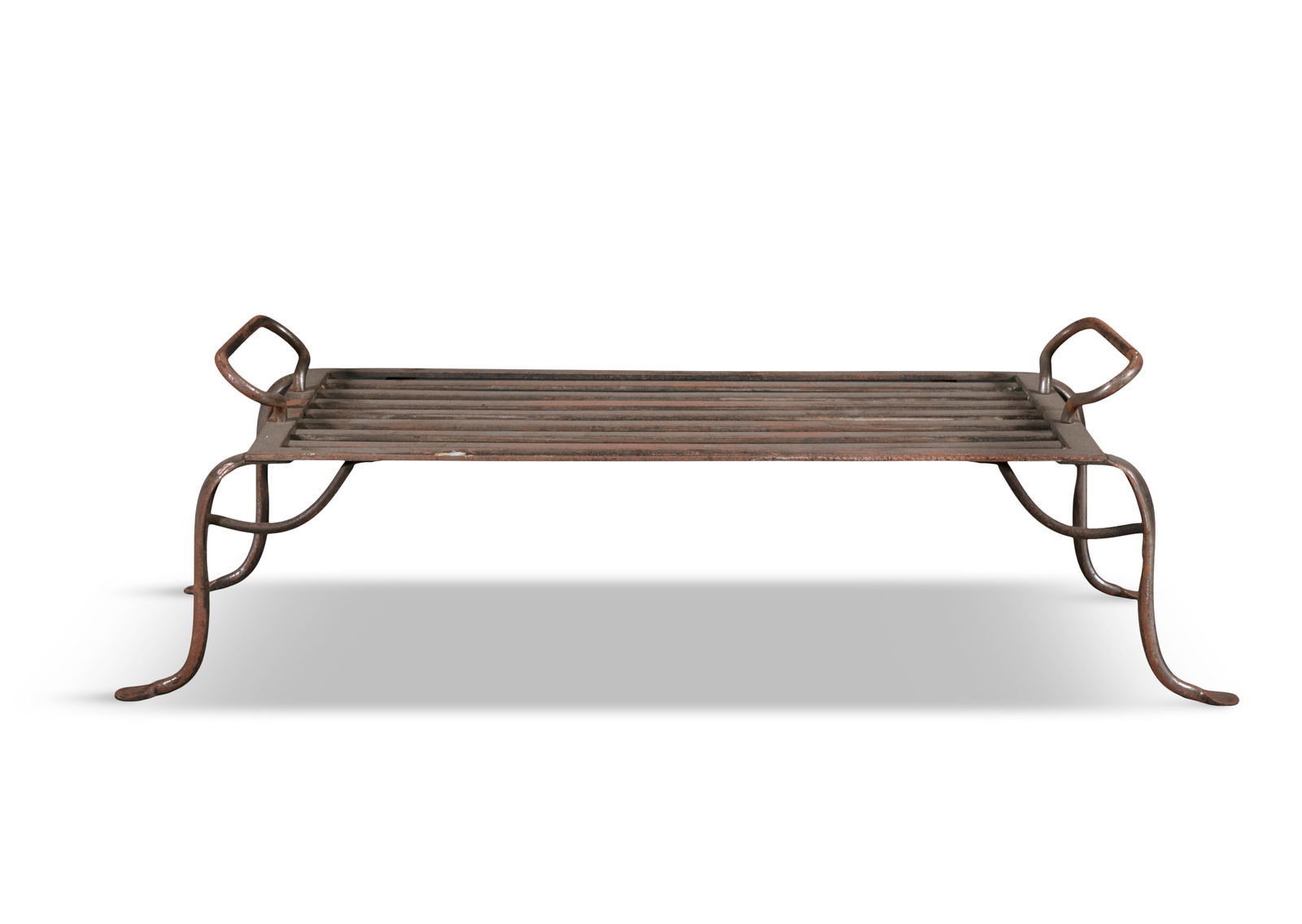 A VICTORIAN POLISHED STEEL LARGE TRIVET, with nine-bar platform, applied with looped side handles,: A VICTORIAN POLISHED STEEL LARGE TRIVET, with nine-bar platform, applied with looped side handles, on splayed feet, 27cm high, 90cm wide, 38cm deep