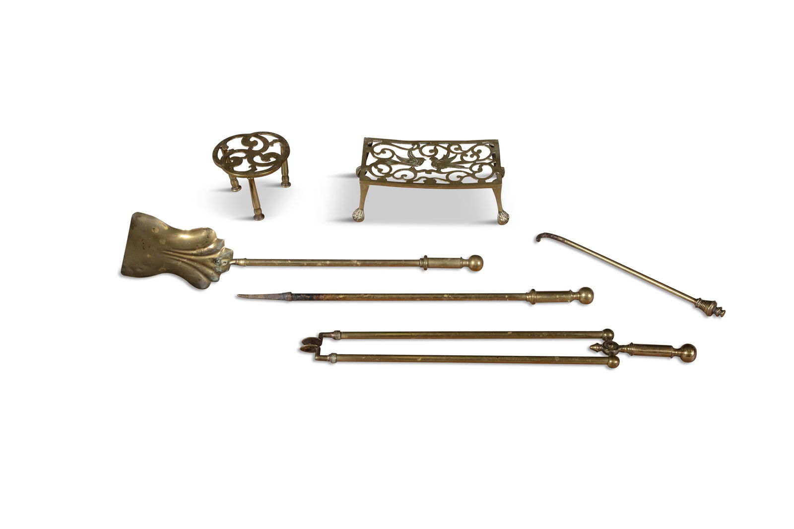 A COLLECTION OF BRASS FIRE TOOLS, comprising two pokers, coal shovel, tong and one large and one: A COLLECTION OF BRASS FIRE TOOLS, comprising two pokers, coal shovel, tong and one large and one small trivet, tongs 63cm long