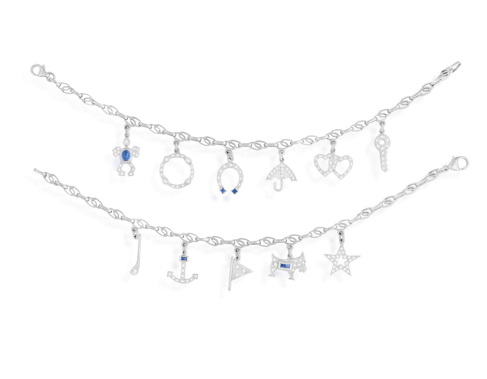 A PAIR OF SAPPHIRE AND DIAMOND CHARM BRACELETS Each fancy-link chain, suspending various charms: A PAIR OF SAPPHIRE AND DIAMOND CHARM BRACELETS Each fancy-link chain, suspending various charms such as a horseshoe, an anchor, a flag, an umbrella etc...each highlighted with brilliant-cut diamonds a