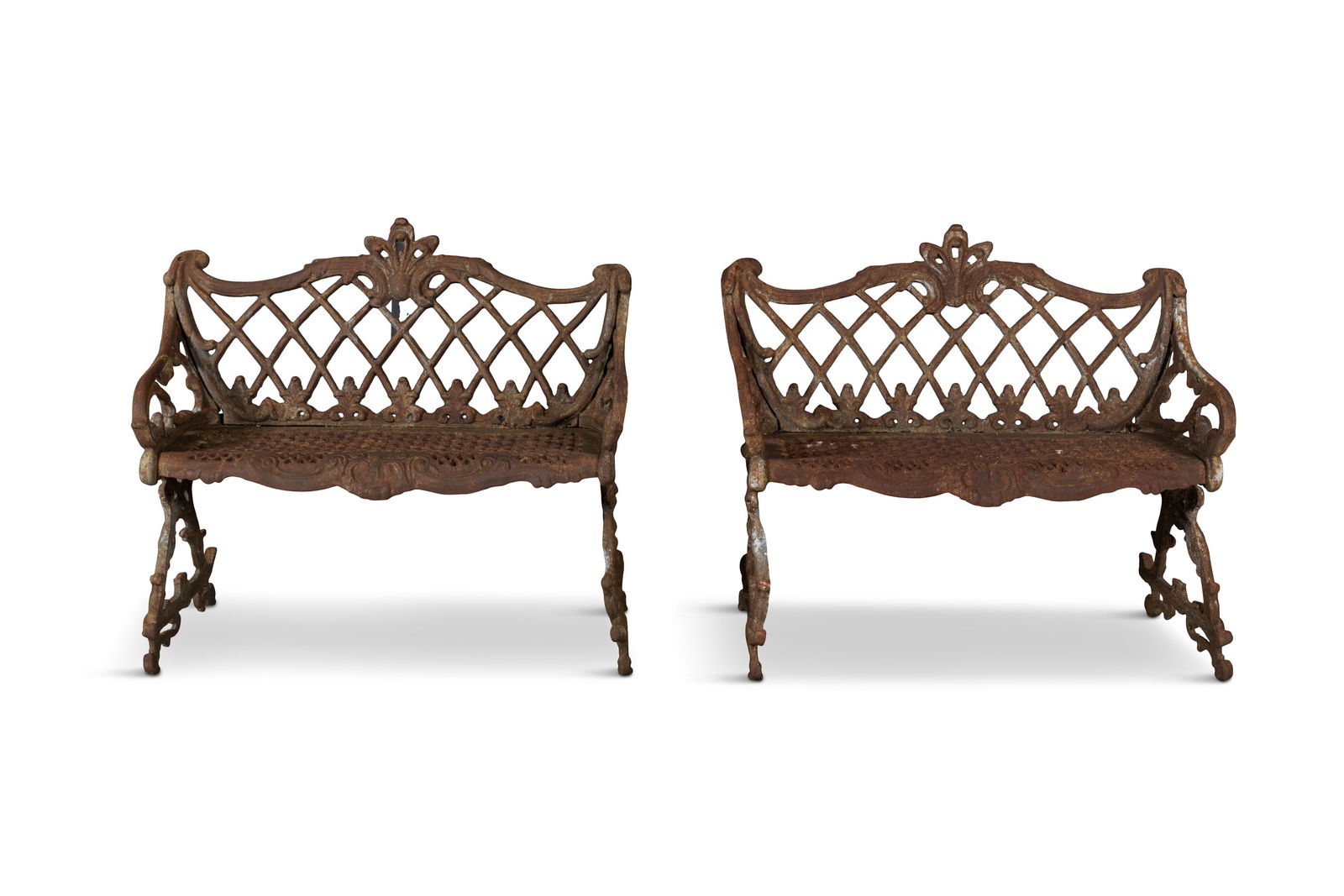 A PAIR OF VICTORIAN CAST IRON BENCHES, each with lattice work back and honeycomb seat panels,: A PAIR OF VICTORIAN CAST IRON BENCHES, each with lattice work back and honeycomb seat panels, rustic side supports and feet. 92cm wide