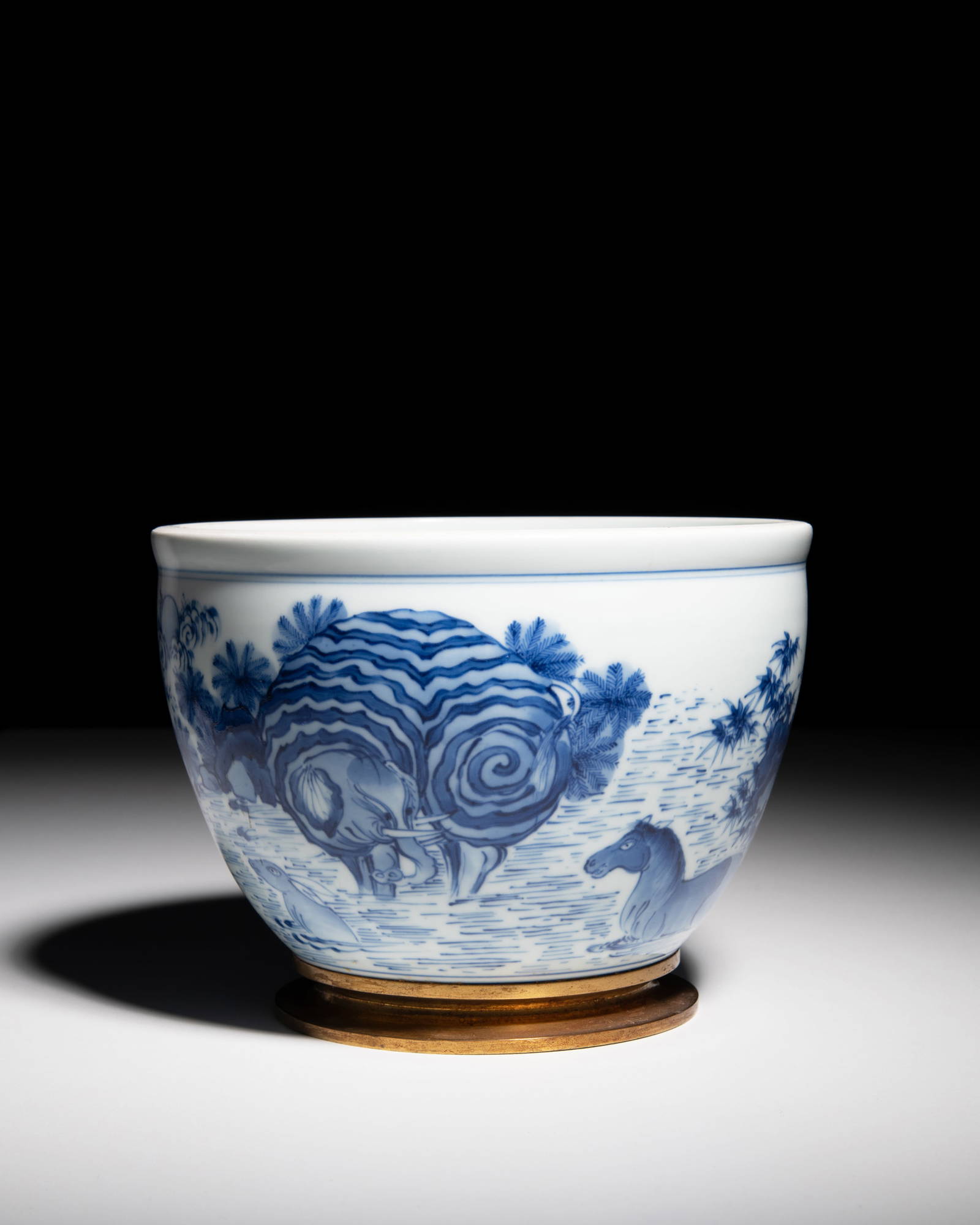A BLUE AND WHITE 'WASHING ELEPHANT' JAR, MOUNTED WITH A GILT-BRONZE FOOT RIM 17__ _______ China,