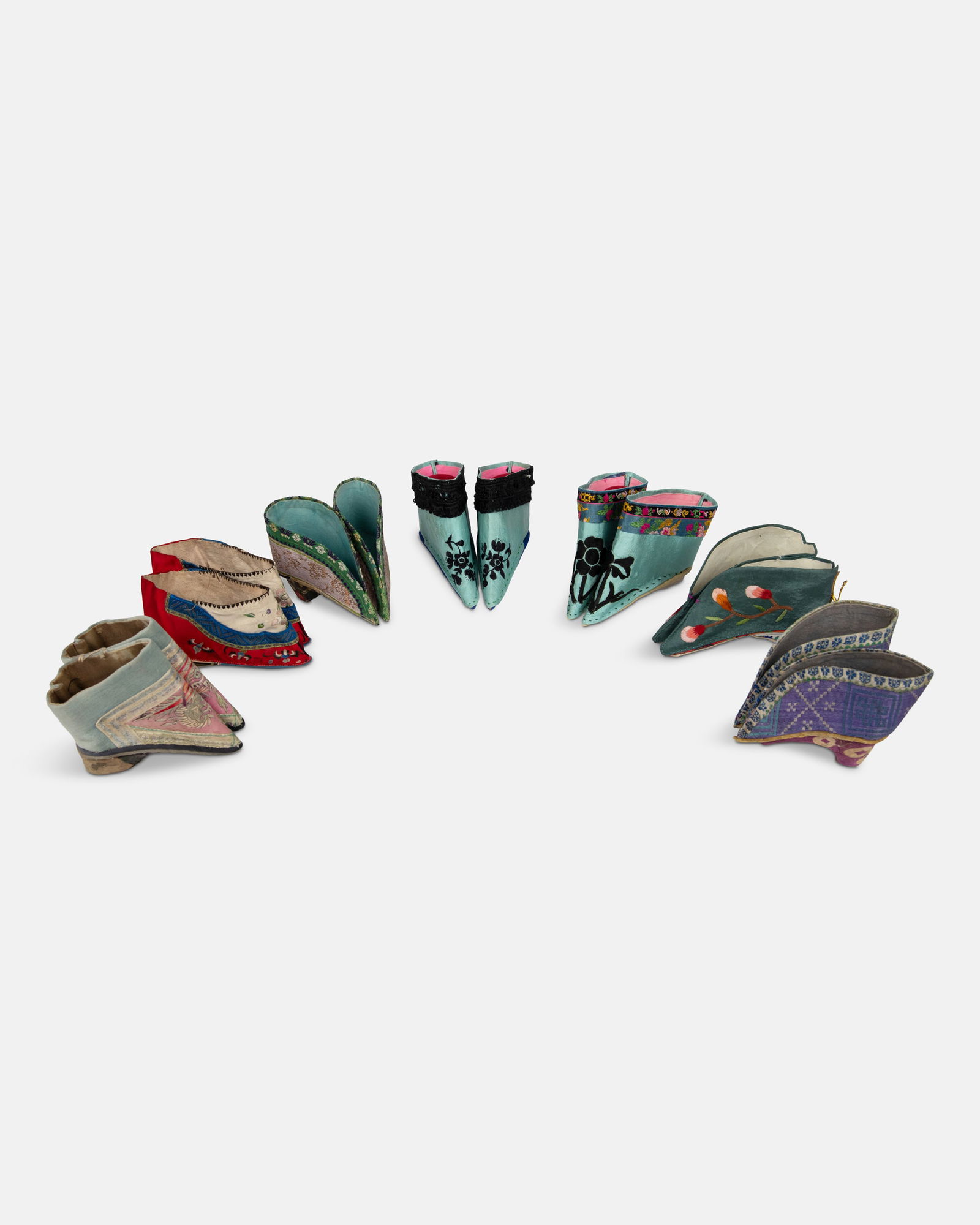 A COLLECTION OF SEVEN PAIRS OF MANCHU WOMEN'S SILK EMBROIDERY SHOES __ __________ China, late: A COLLECTION OF SEVEN PAIRS OF MANCHU WOMEN'S SILK EMBROIDERY SHOES __ __________ China, late Qing dynasty L.8.2-11.5cm