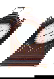 A MAHOGANY CASED FRENCH MANTLE CLOCK, 19TH CENTURY  with brass carrying handle, arched top: A MAHOGANY CASED FRENCH MANTLE CLOCK, 19TH CENTURY with brass carrying handle, arched top surmounted with four brass finials, over glazed circular dial inked with Arabic numerals on pedestal base and