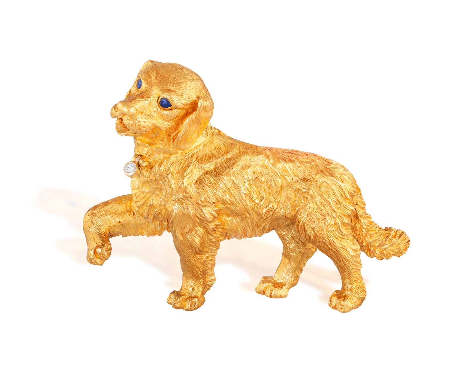 TIFFANY & CO.: A GOLD AND GEM-SET BROOCH, 1996  Modelled as textured gold dog, with circular-cut (1 of 4)