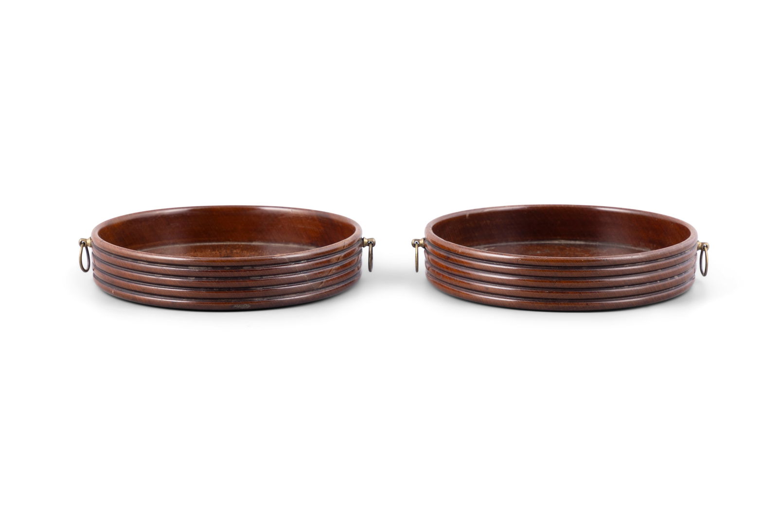 A PAIR OF GEORGE III DECANTER COASTERS WITH BRASS HANDLES circular form, with ribbed side walls.: A PAIR OF GEORGE III DECANTER COASTERS WITH BRASS HANDLES circular form, with ribbed side walls. 18cm diameter