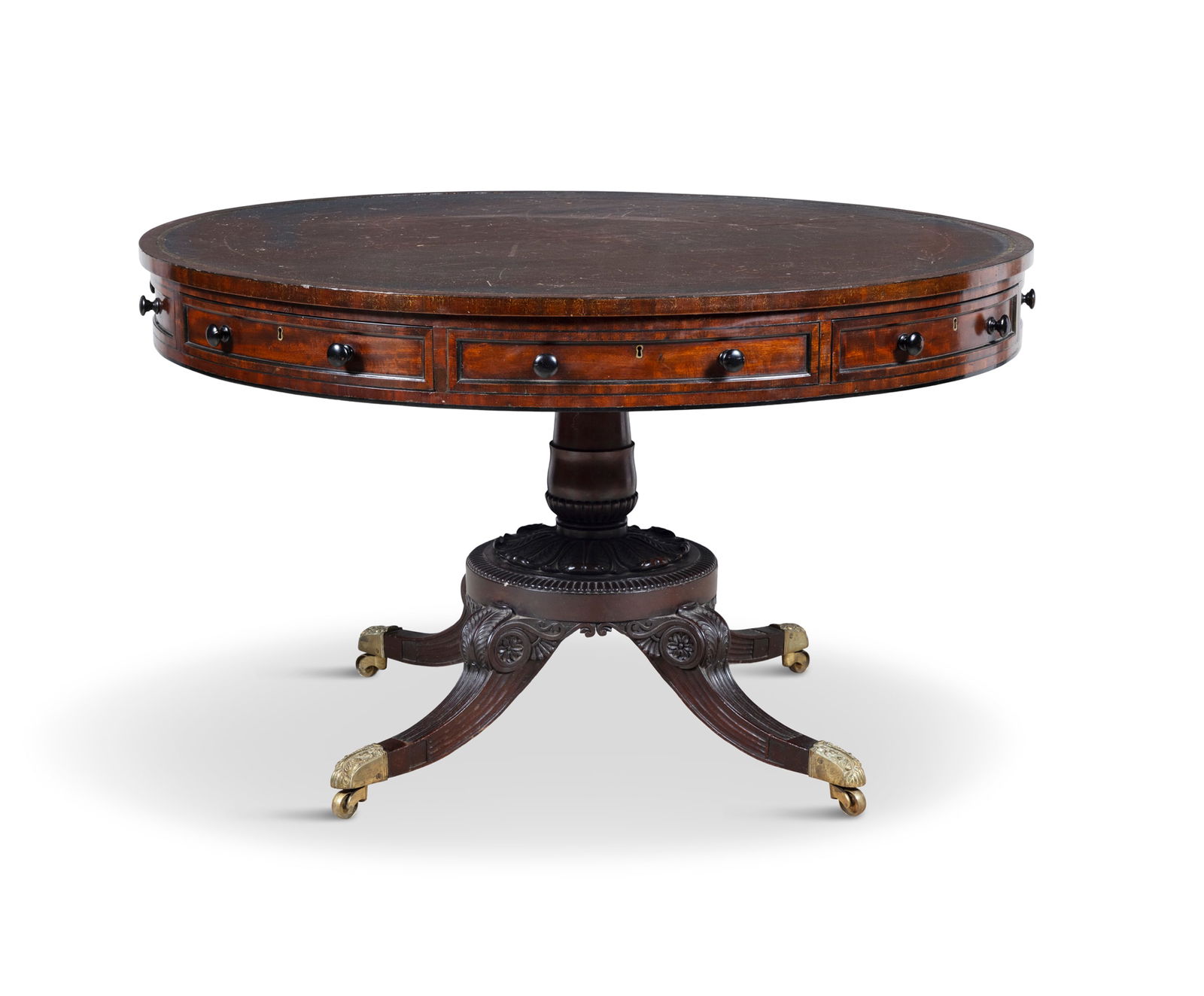 A VICTORIAN MAHOGANY DRUM TABLE, MID 19TH CENTURY stamped Kerby, 545 New Oxford St. London, the: A VICTORIAN MAHOGANY DRUM TABLE, MID 19TH CENTURY stamped Kerby, 545 New Oxford St. London, the circular top inset with leather having gilt tooled edges and divisions, over a frieze of four short and