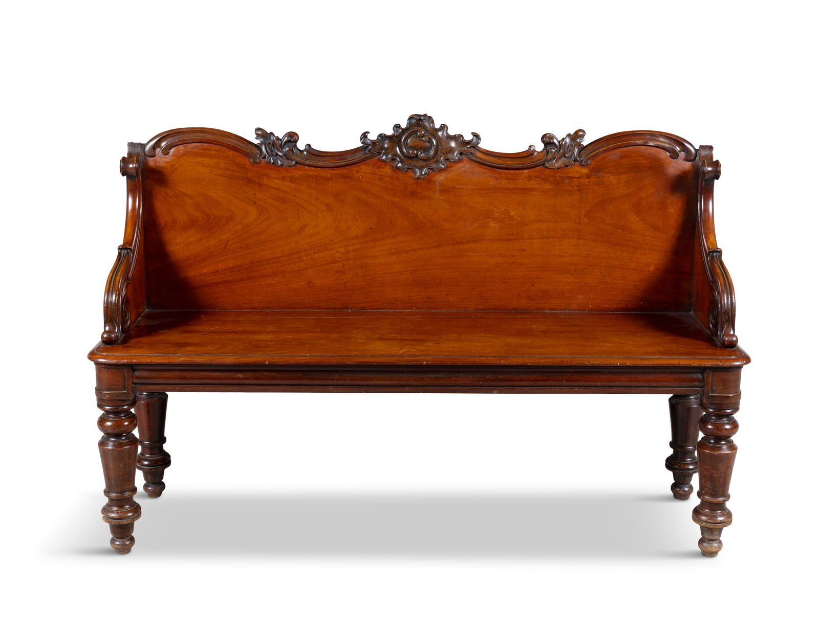 A VICTORIAN MAHOGANY HALL BENCH, MID 19TH CENTURY with raised scrollwork panel back and sides,: A VICTORIAN MAHOGANY HALL BENCH, MID 19TH CENTURY with raised scrollwork panel back and sides, solid panel seat and turned tapering legs, 93cm high, 148cm wide, 43cm deep