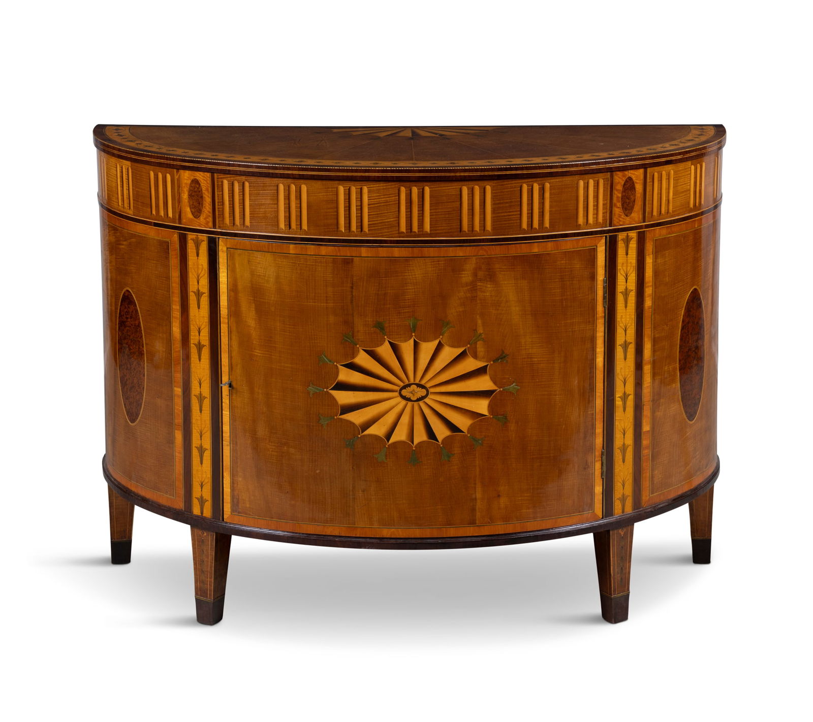 A FINE GEORGE III HAREWOOD AND MARQUETRY COMMODE ATTRIBUTED TO WILLIAM MOORE OF DUBLIN, the: A FINE GEORGE III HAREWOOD AND MARQUETRY COMMODE ATTRIBUTED TO WILLIAM MOORE OF DUBLIN, the D-shaped top crossbanded with rosewood and inlaid within a half fan medallion, radiating lines and bellflowe