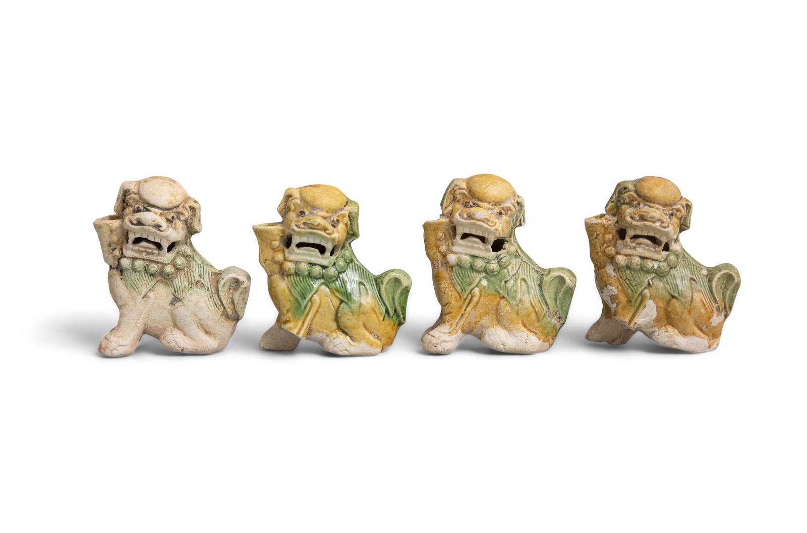 FOUR BISCUIT WATER-DROPPER FIGURES OF SEATED BUDDHIST LIONS China, Yongzheng period, circa 1725