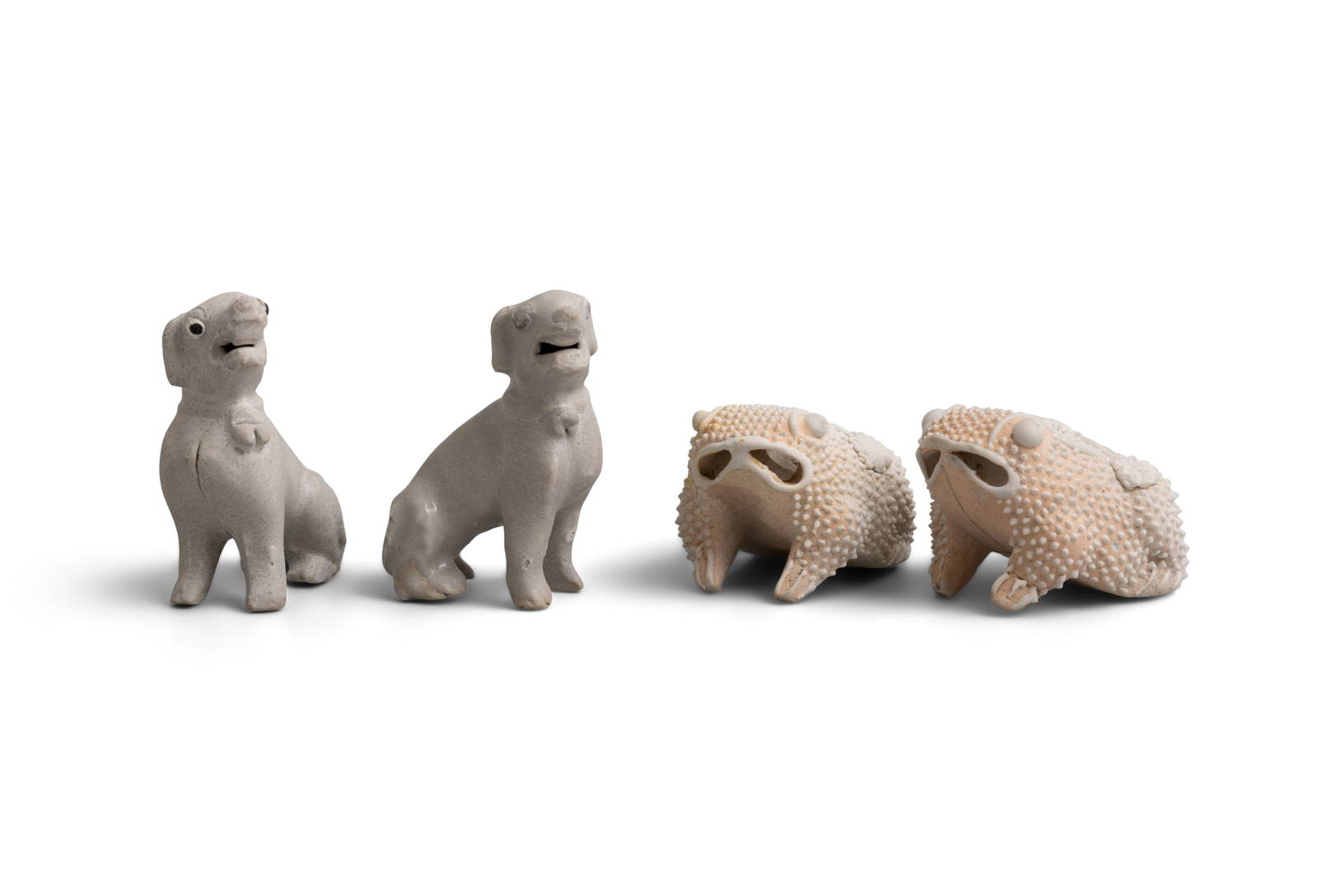 TWO SMALL LIGHT BROWN TOAD WATER DROPPERS AND TWO WHITE FIGURES OF SEATED HOUNDS China, Yongzheng