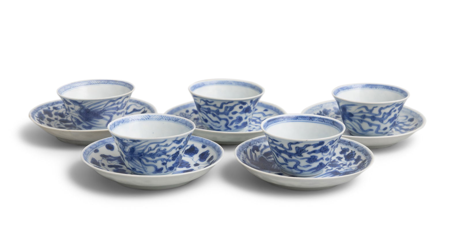 FIVE ‘TWO PHOENIX’ PATTERN BLUE AND WHITE TEABOWLS AND SAUCERS China, Yongzheng period,: FIVE ‘TWO PHOENIX’ PATTERN BLUE AND WHITE TEABOWLS AND SAUCERS China, Yongzheng period, circa 1725 with multiple long-tailed phoenix in flight among lotus flowers, the center with a stylis