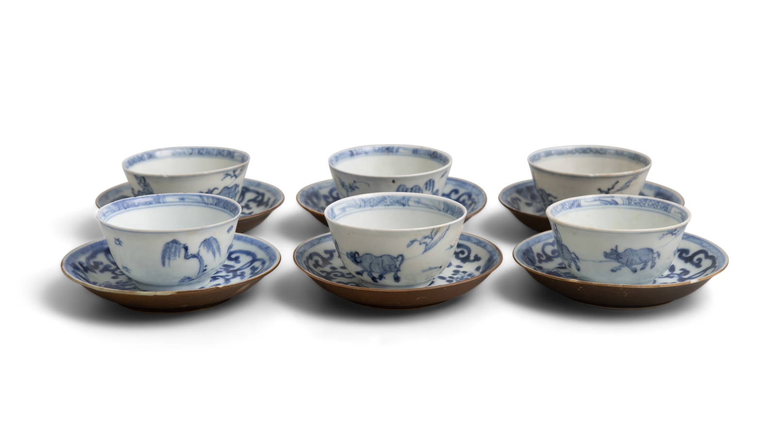 SIX BLUE AND WHITE ‘BOY ON A BUFFALO’ PATTERN TEABOWLS AND ‘FLOWERS’ SAUCERS