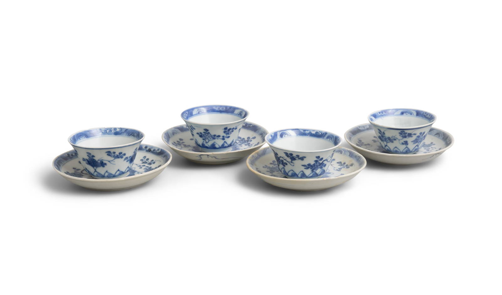 FOUR ‘RADIATING FLOWERS’ PATTERN BLUE AND WHITE TEABOWLS AND SAUCERS China, Yongzheng