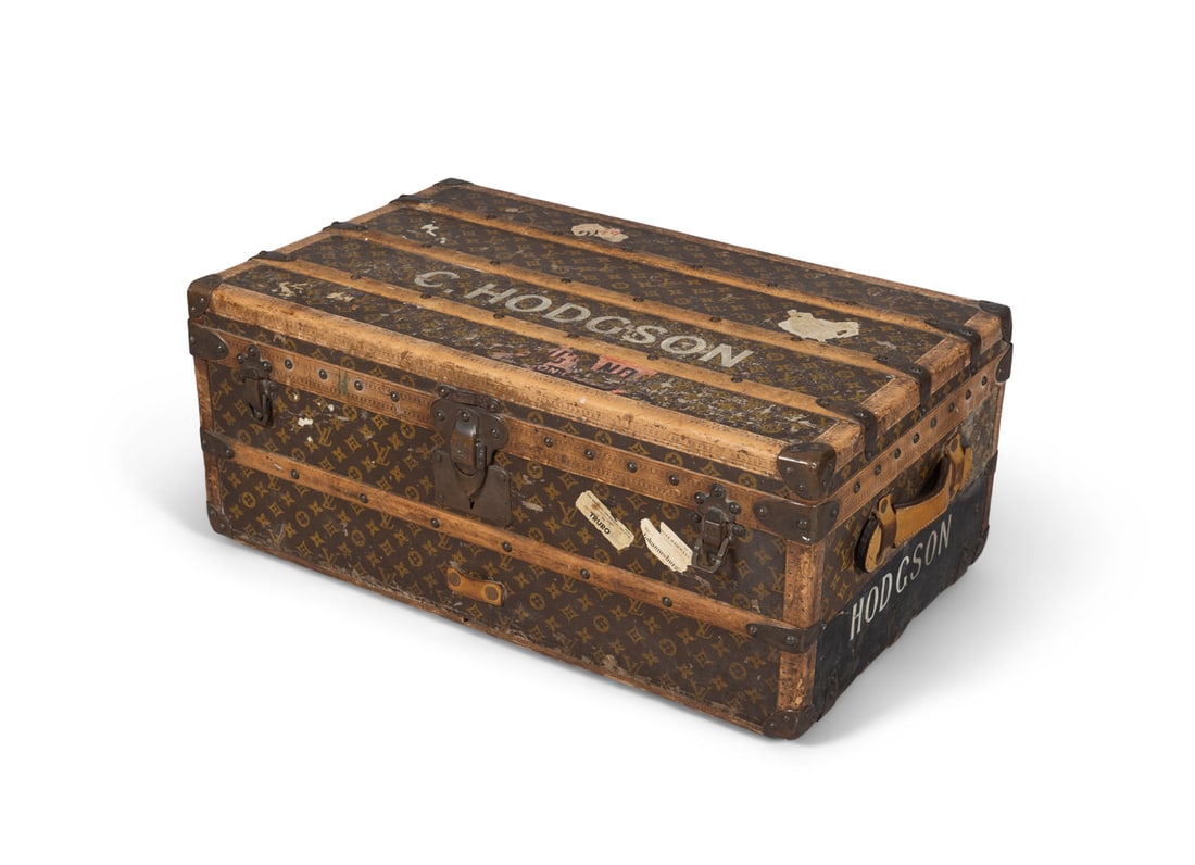 A LOUIS VUITTON TRAVEL TRUNK, EARLY 20TH CENTURY CIRCA 1913 the lid opening to reveal a canvas: A LOUIS VUITTON TRAVEL TRUNK, EARLY 20TH CENTURY CIRCA 1913 the lid opening to reveal a canvas lined interior, the exterior with stamped and patented locks and carrying side handle (one missing), stam