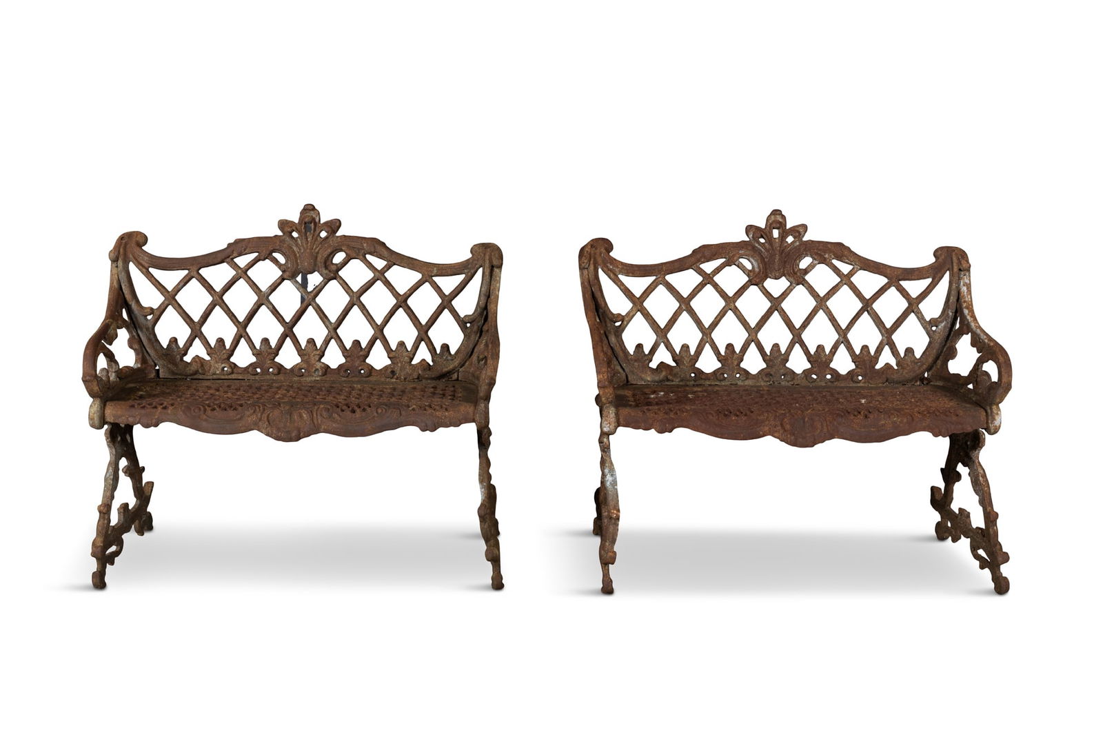 A PAIR OF VICTORIAN CAST IRON BENCHES, each with lattice work back and honeycomb seat panels,: A PAIR OF VICTORIAN CAST IRON BENCHES, each with lattice work back and honeycomb seat panels, rustic side supports and feet. 92cm wide