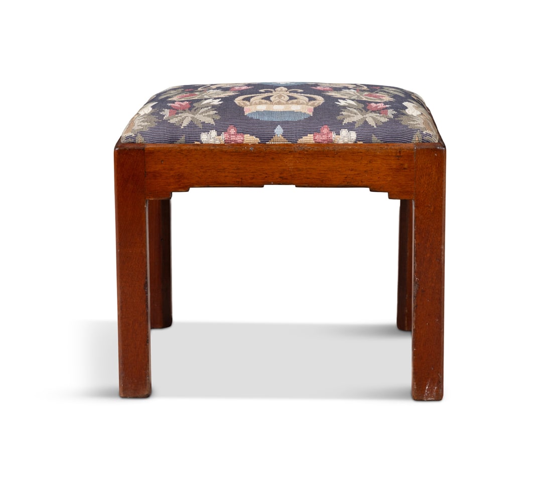 AN IRISH MAHOGANY FRAMED UPHOLSTERED STOOL ATTRIBUTED TO JAMES HICKS OF PEMBROKE STREET, DUBLIN: AN IRISH MAHOGANY FRAMED UPHOLSTERED STOOL ATTRIBUTED TO JAMES HICKS OF PEMBROKE STREET, DUBLIN fitted with rectangular seat cushion, upholstered with needlepoint fabric, with coronet and fleur-de-ley