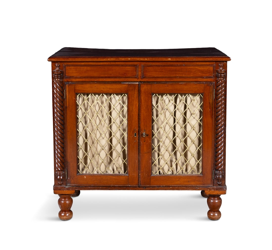A MAHOGANY AND BRASS SIDE CABINET, 19TH CENTURY the moulded panel top above a pair of brass grill: A MAHOGANY AND BRASS SIDE CABINET, 19TH CENTURY the moulded panel top above a pair of brass grill doors with fabric lining, flanked by barley twist pilasters. 86cm high, 88cm wide, 49cm deep