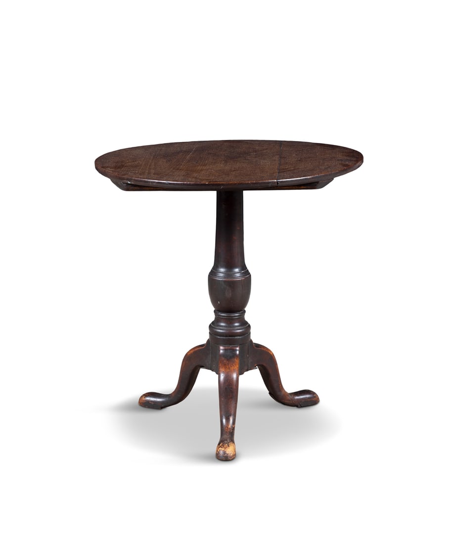 A SMALL OAK TILT-TOP OCCASSIONAL TABLE the circular top over a baluster centre pillar on downswept (1 of 4)