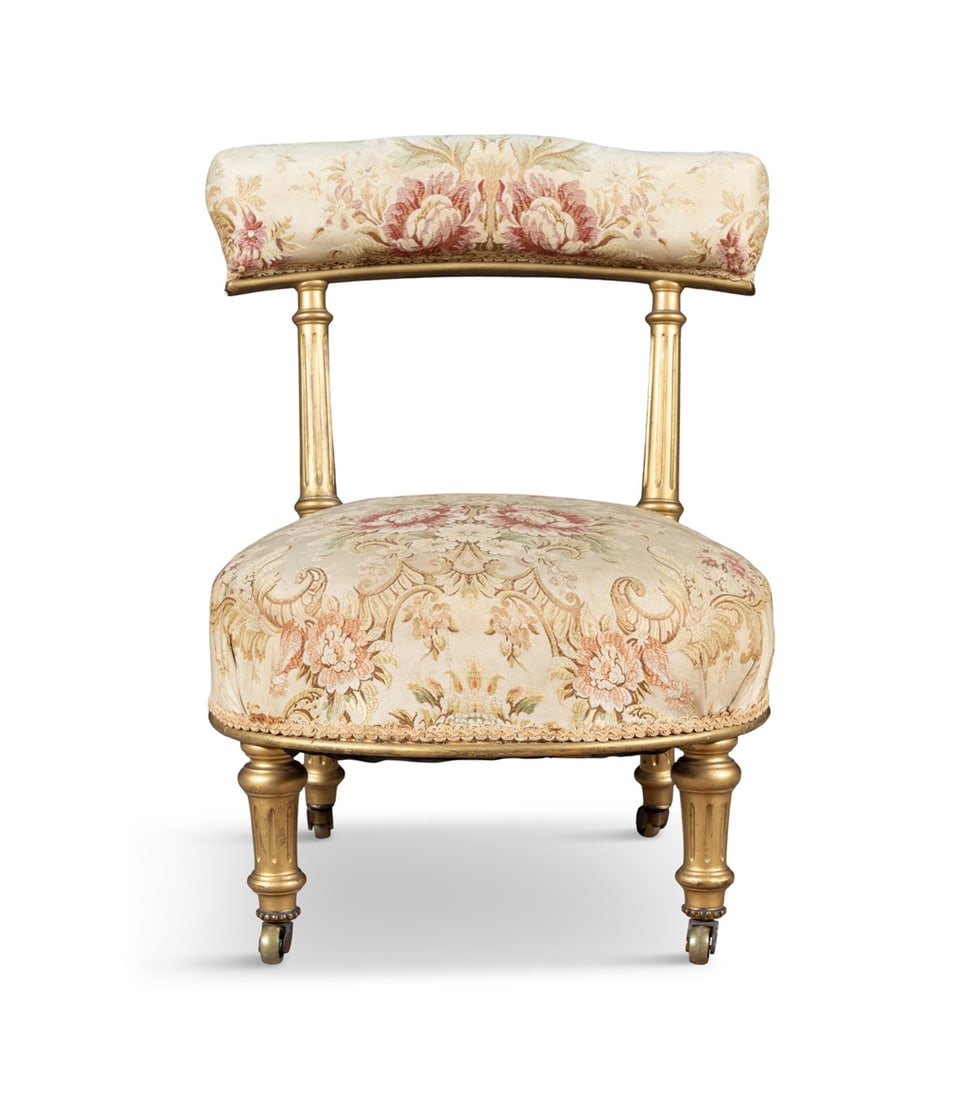 A LADIES GILTWOOD PRIEDIU, 19TH CENTURY upholstered back and seat in floral tapestry fabric, on: A LADIES GILTWOOD PRIEDIU, 19TH CENTURY upholstered back and seat in floral tapestry fabric, on short fluted supports and castors. 60cm high