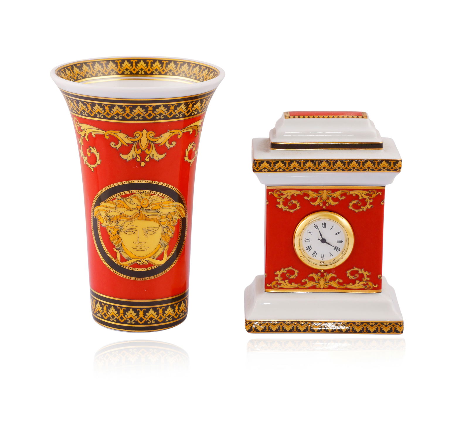 VERSACE FOR ROSENTHAL: A PORCELIN MEDUSA FLOWER VASE AND A TABLE CLOCK The small tapered porcelain : VERSACE FOR ROSENTHAL: A PORCELIN MEDUSA FLOWER VASE AND A TABLE CLOCK The small tapered porcelain vase depicting the head of Medusa, on a red background with yellow and golden foliate details, in por