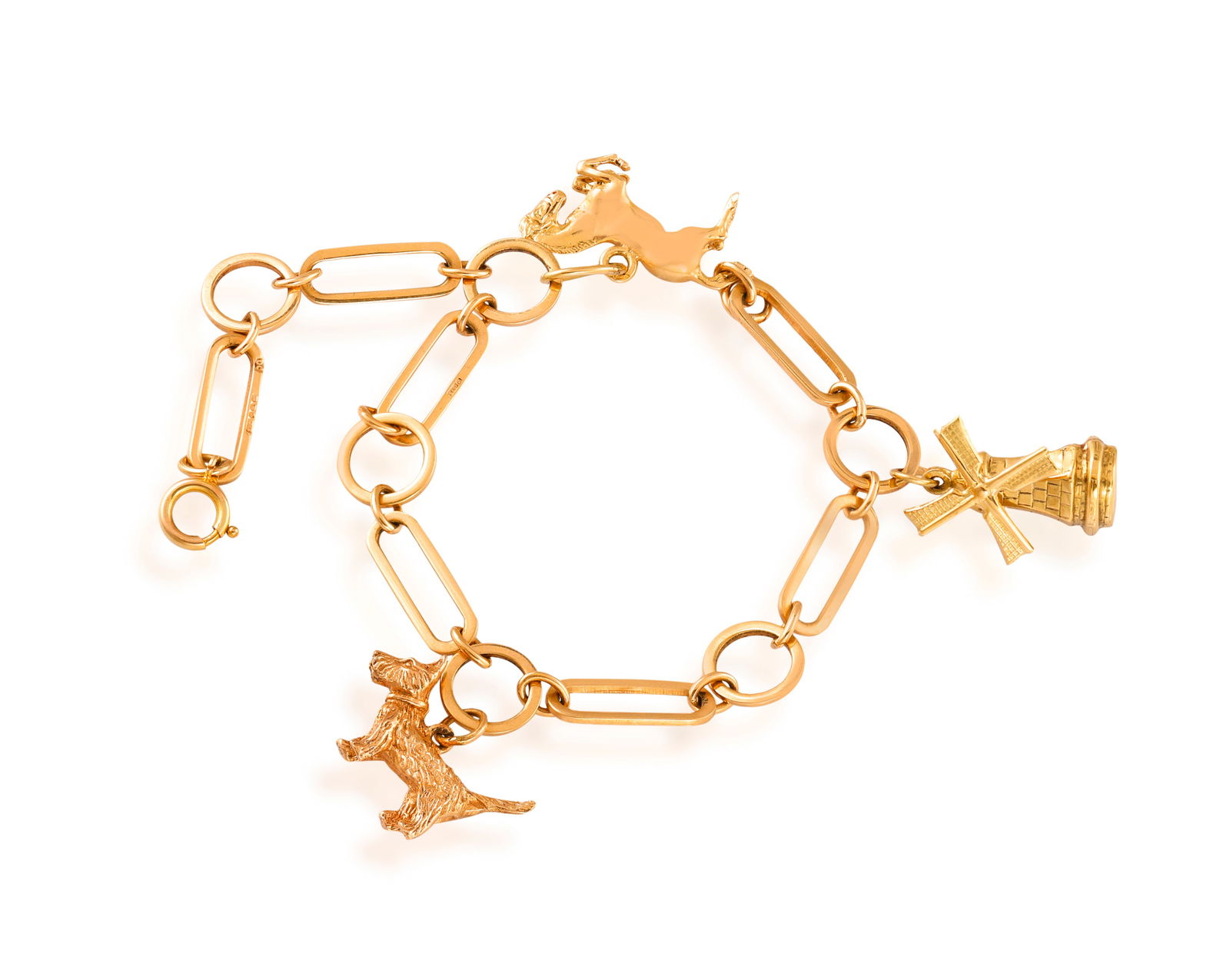 A CHARM BRACELET The bracelet composed of oval and circular-shaped links alternatingly set, between: A CHARM BRACELET The bracelet composed of oval and circular-shaped links alternatingly set, between cable-connectors, set with three charms, including a jumping horse, a dog and a windmill, in 9K gold