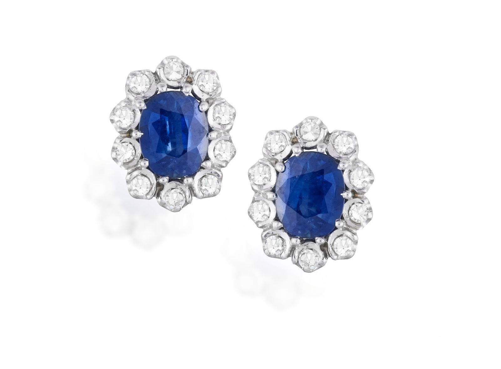 A PAIR OF SAPPHIRE AND DIAMOND EARRINGS Each set with a cushion-shaped sapphire weighing (1 of 2)