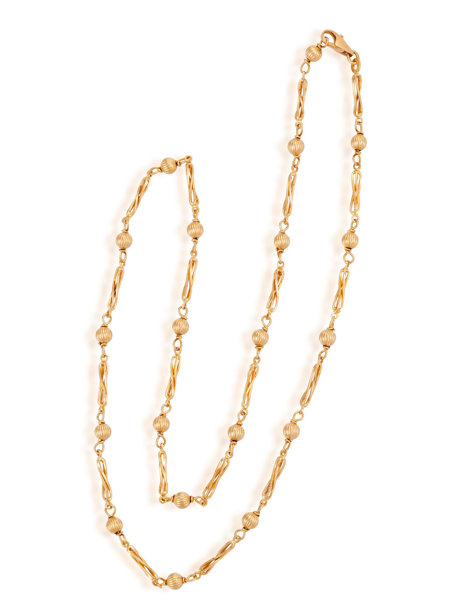 A GOLD CHAIN NECKLACE Composed of reeded beads and fancy-shaped links between loop connectors, in 9 (1 of 2)